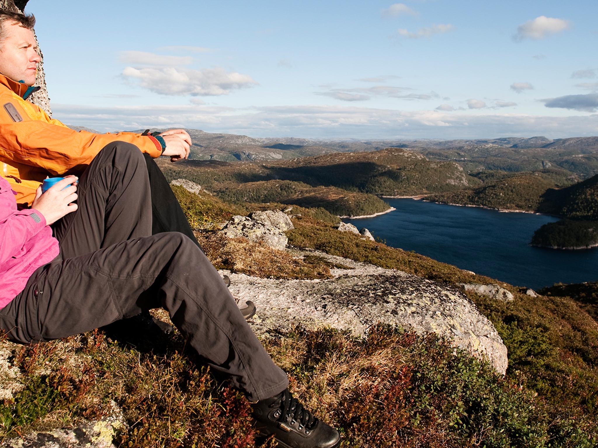 Two people enjoying the view of Sirdal's mountain landscape