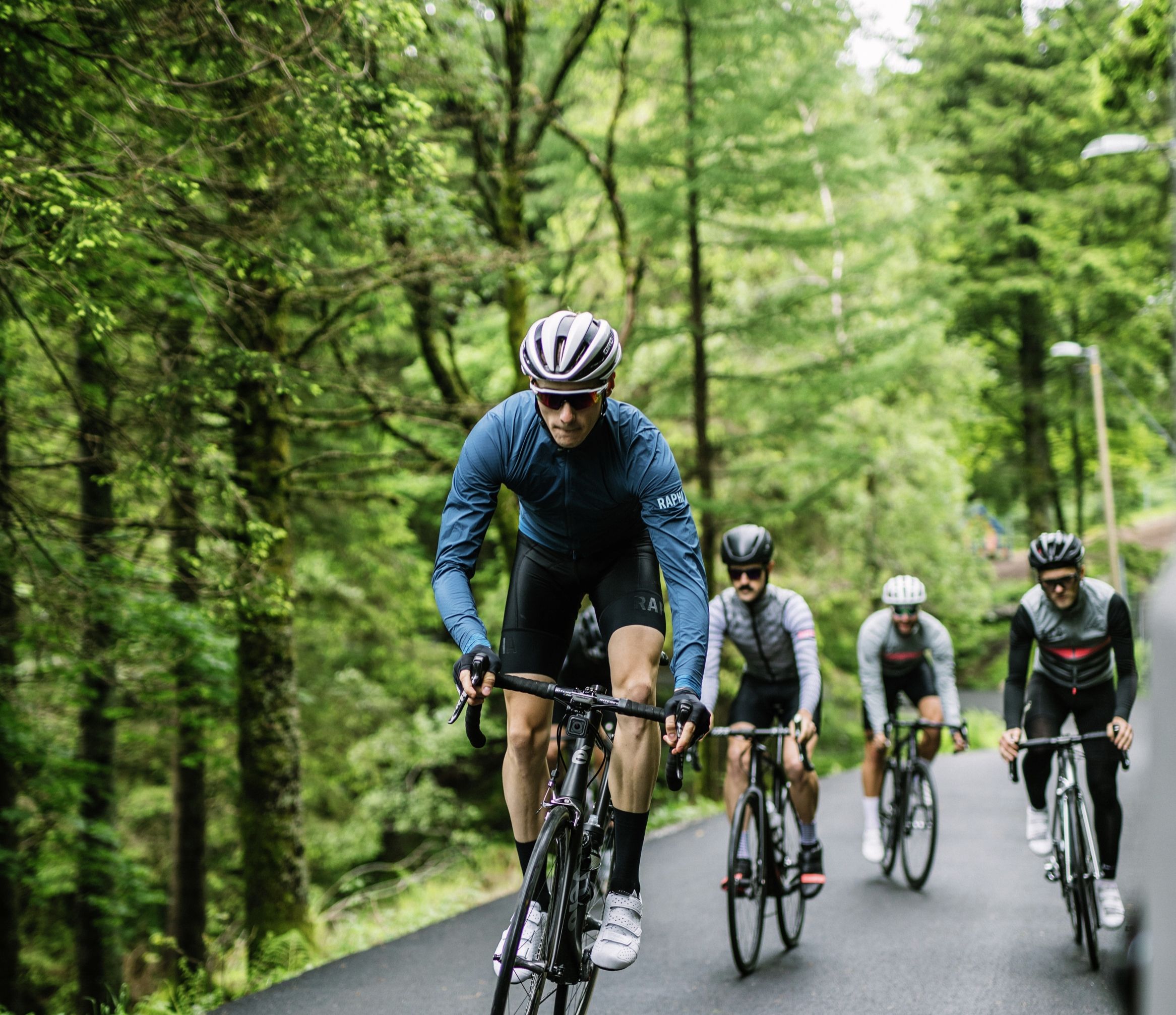 A group of road cyclists biking through Fjord Norway
