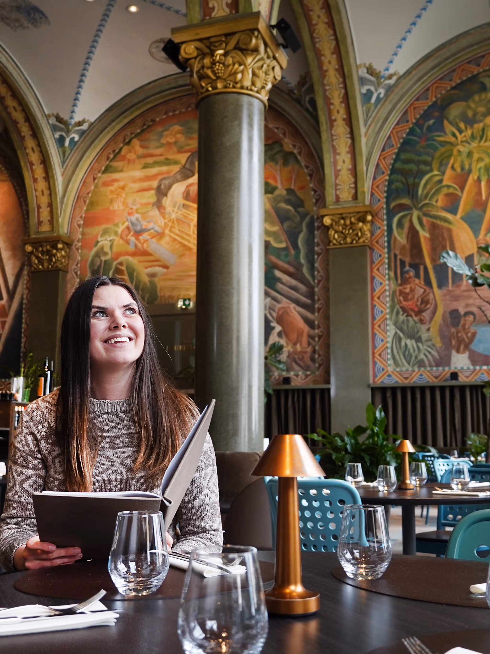 Woman sitting in Frescohallen Restaurant - Bergen Børs Hotel
