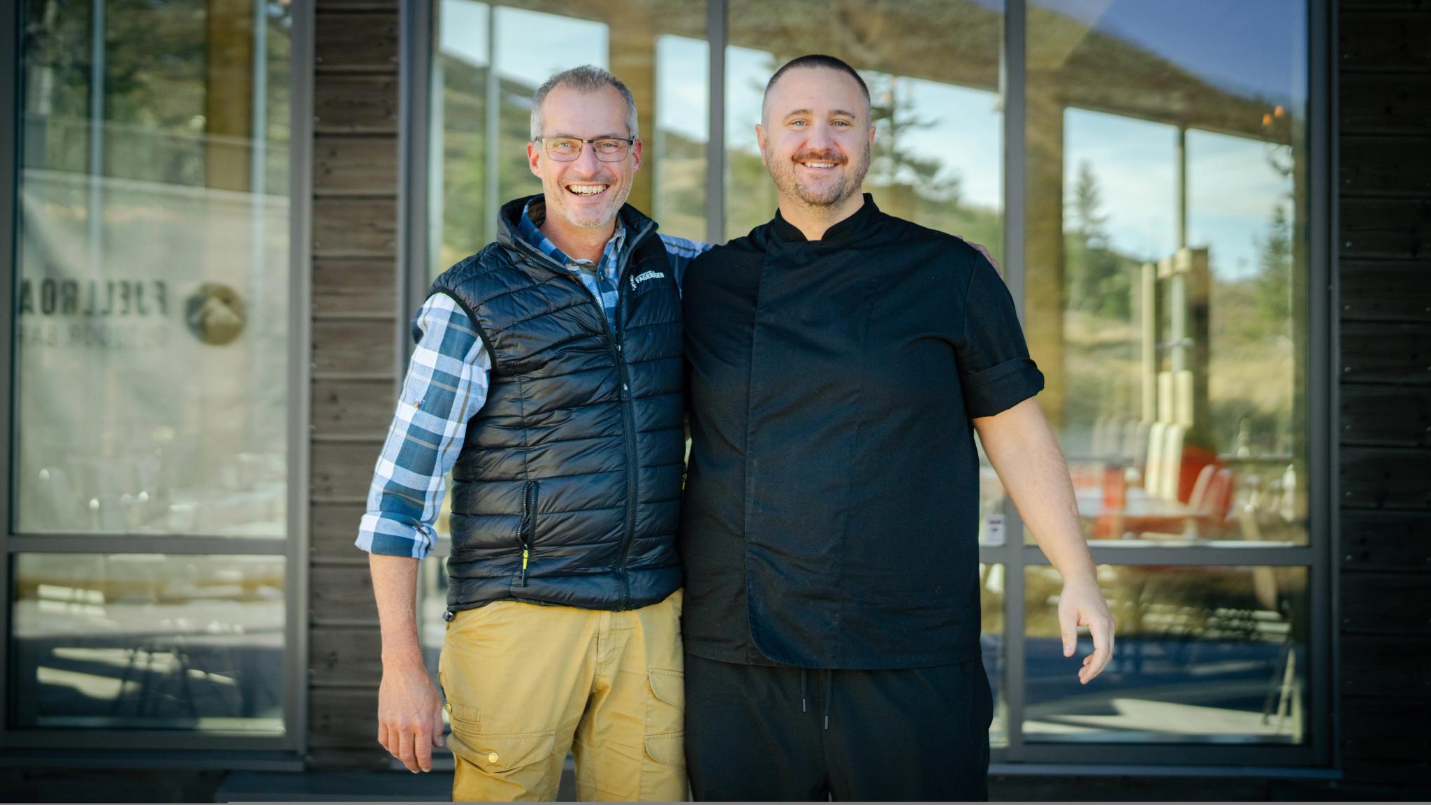 Two men smiling.