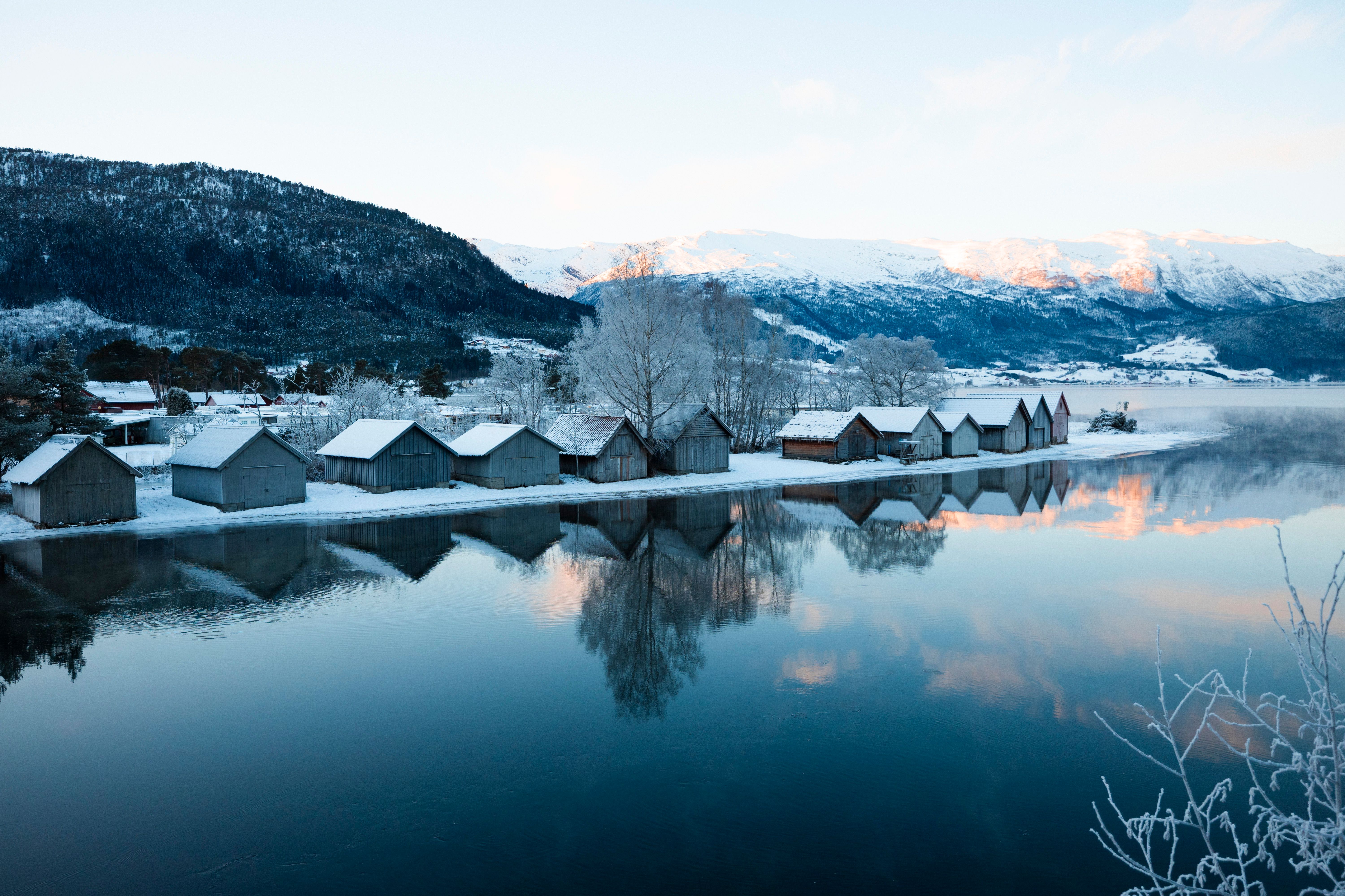 Wooden houses along a fjord in winter