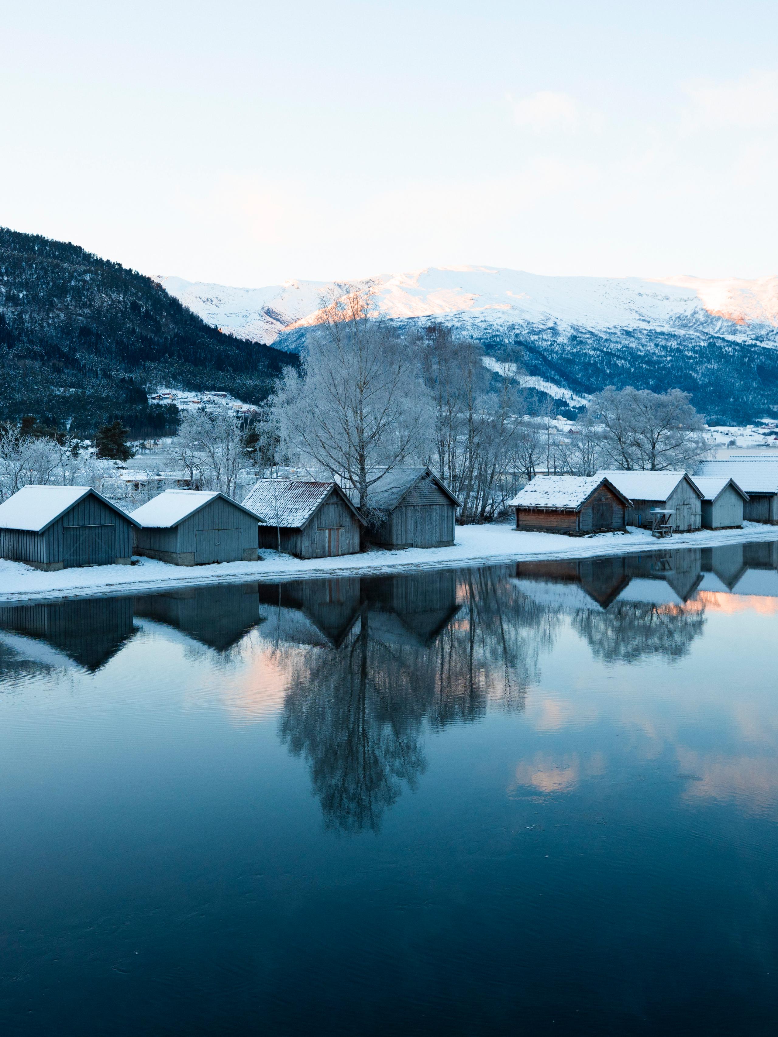 Wooden houses along a fjord in winter