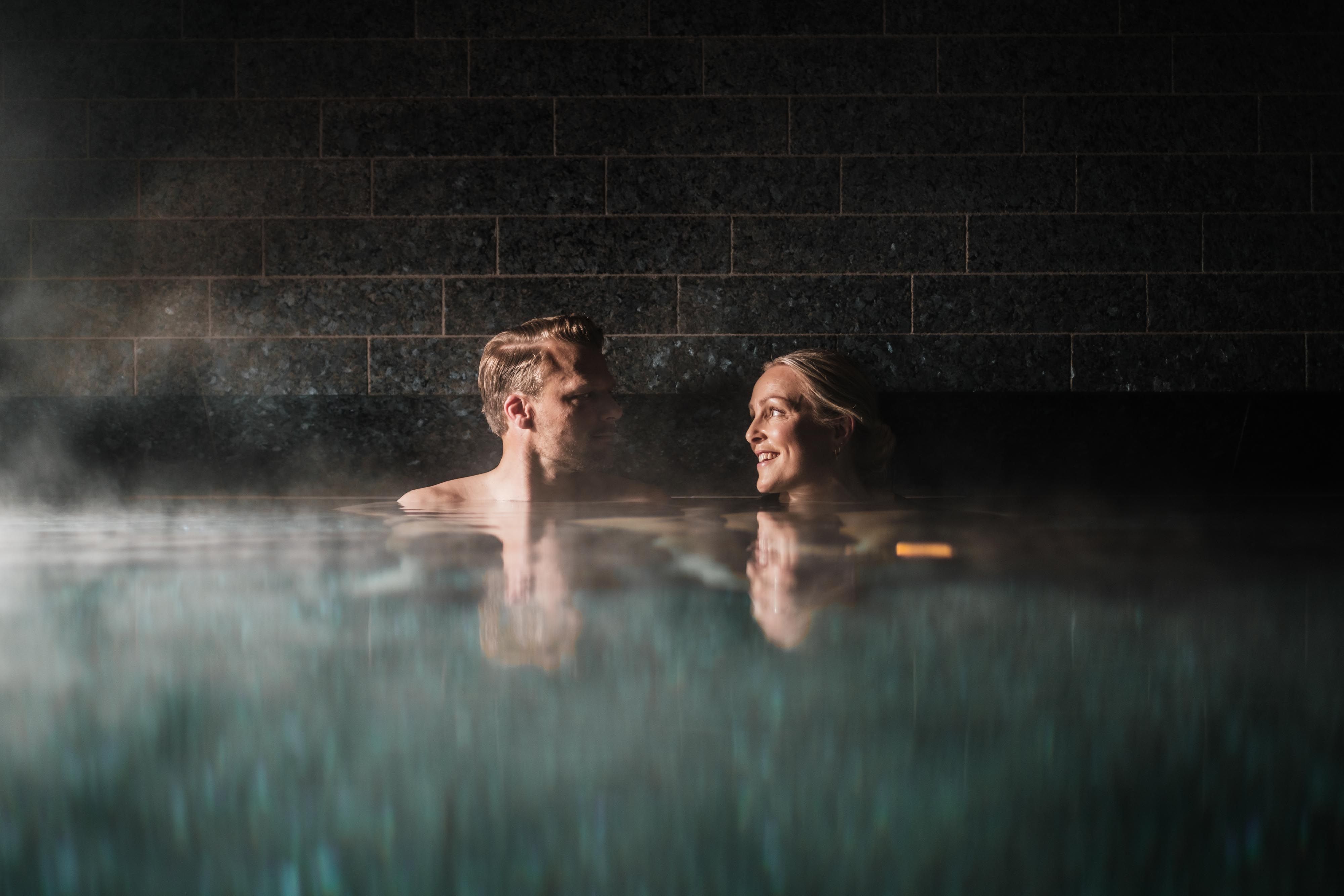 A couple in a heated pool.