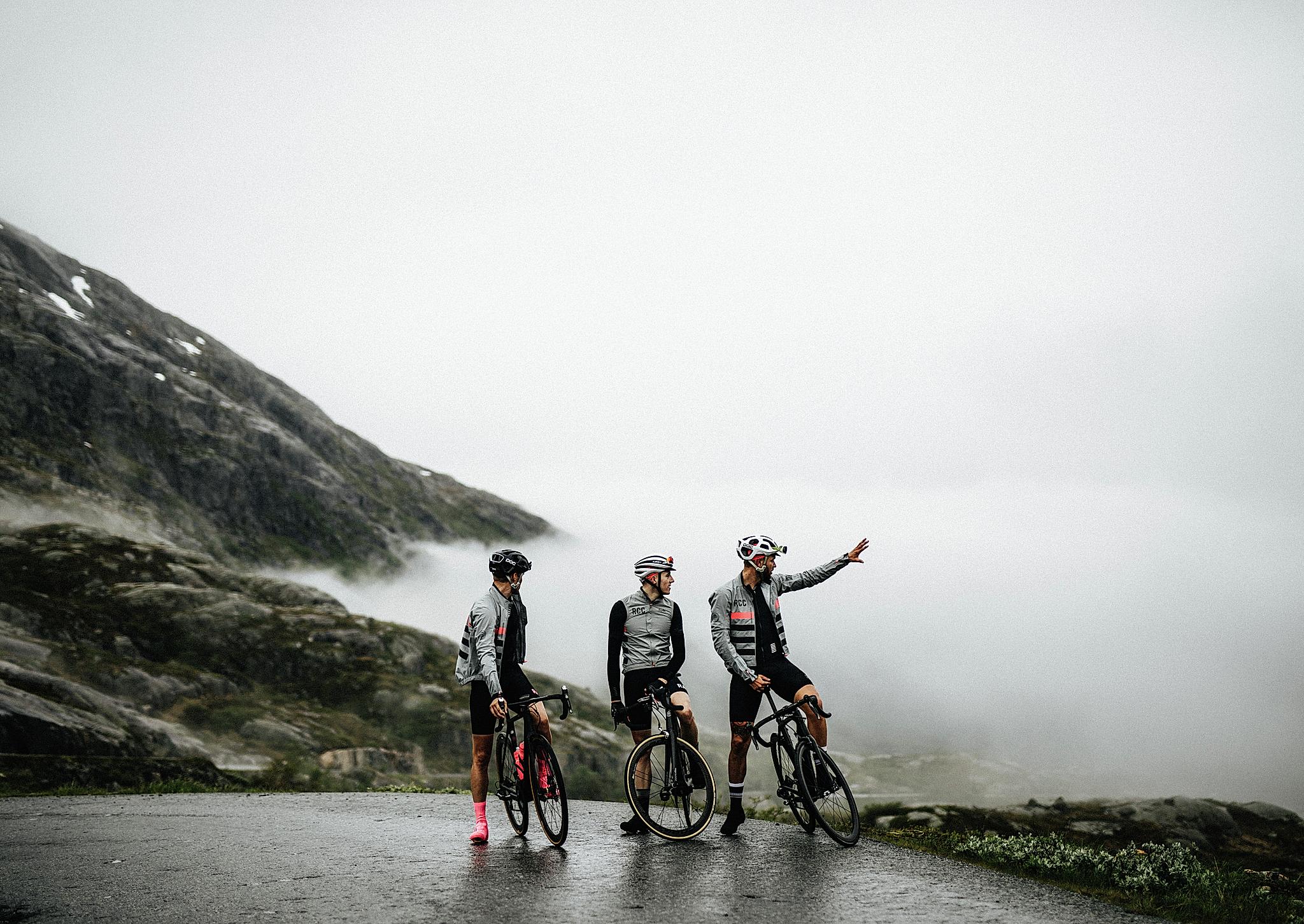 Three road cyclists in fog in Fjord Norway