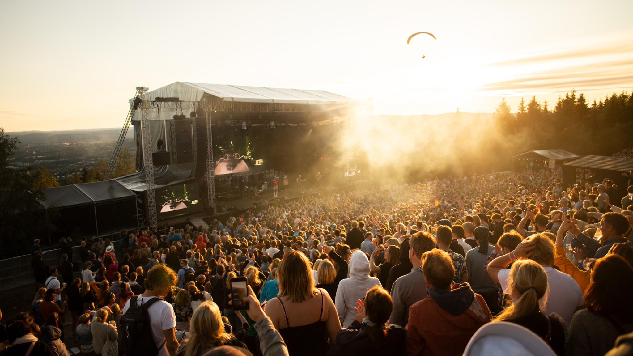 A band performing in front of a large crowd at the OverOslo music festival at Grefsenkollen in Oslo, Eastern Norway