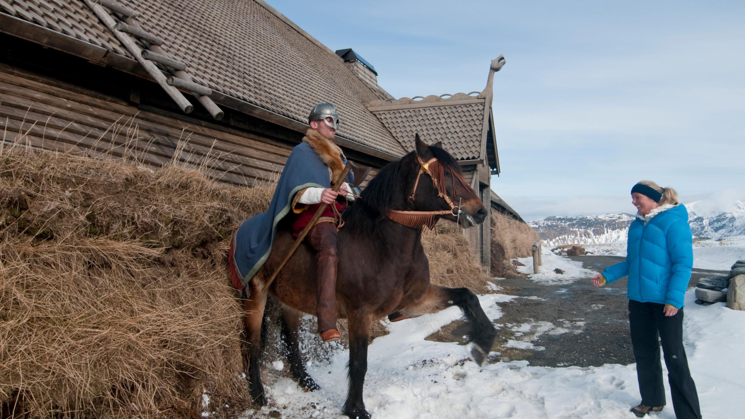A Viking on his horse is posing for visitors at Lofotr Viking Museum in Lofoten, Northern Norway