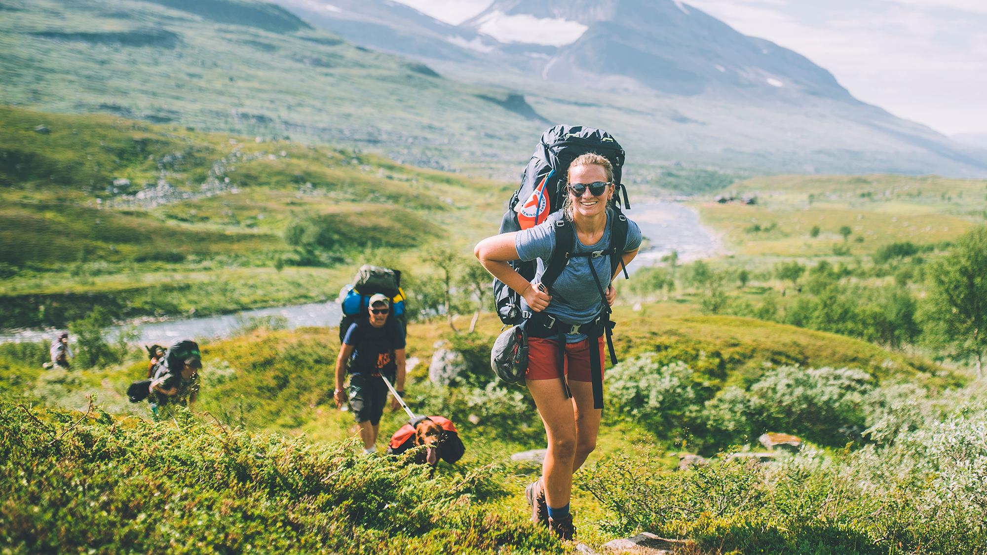 People summer hiking in mountainous landscape in Indre Troms, Northern Norway