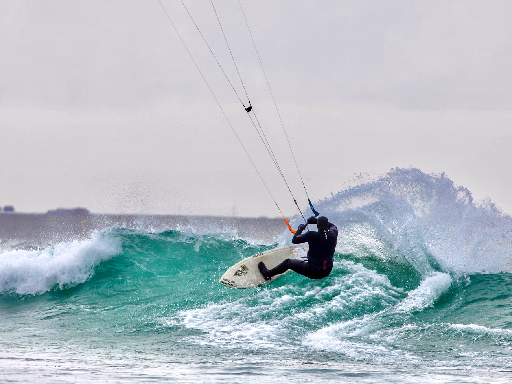A person kiting on a wave in Fjord Norway.