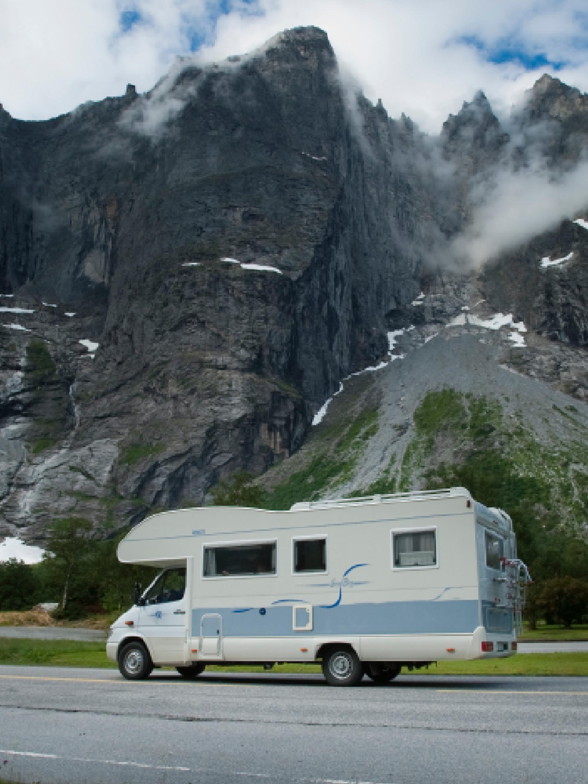 A caravan passing the Troll Wall in Norway