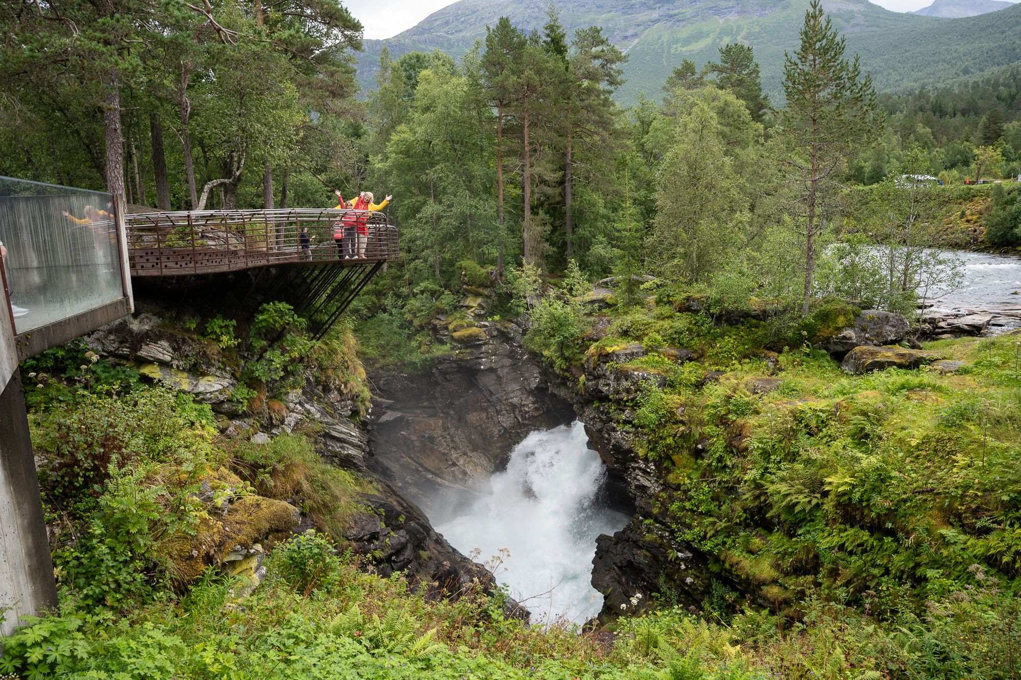 People on a viewing balcony looking down into a gorge.