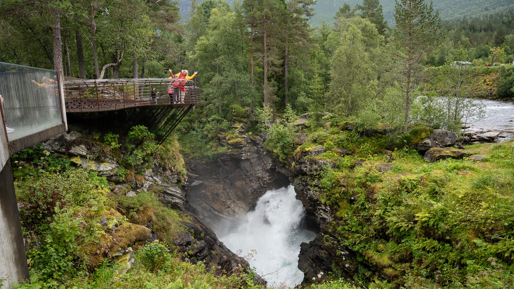 People on a viewing balcony looking down into a gorge.