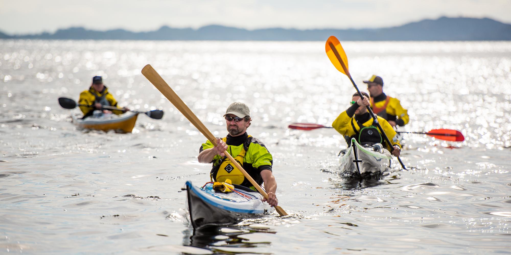 A group of people are kayaking outside of Sotra in Fjord Norway
