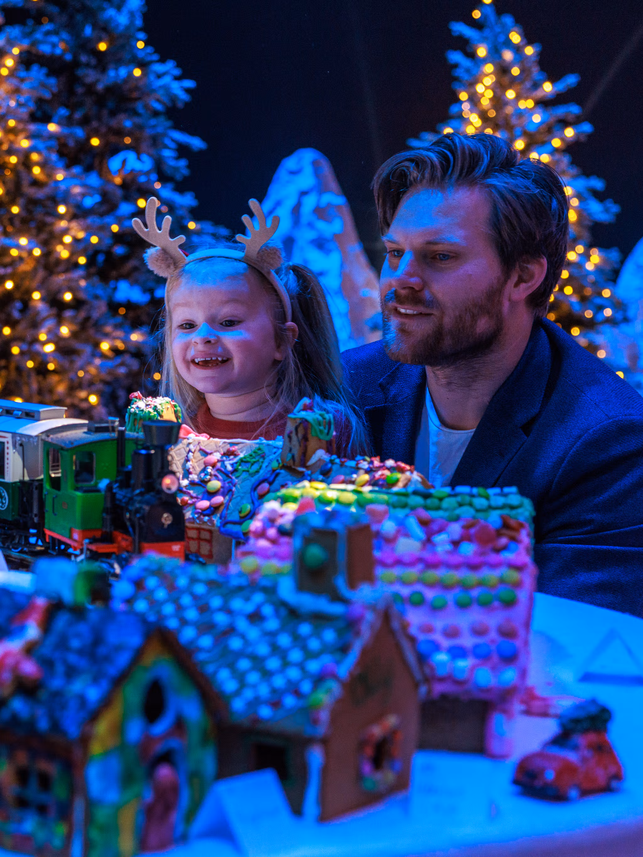 A father and his young daughter looking at the Gingerbread town at the Norwegian Petroleum Museum (Norsk Oljemuseum) in Stavanger