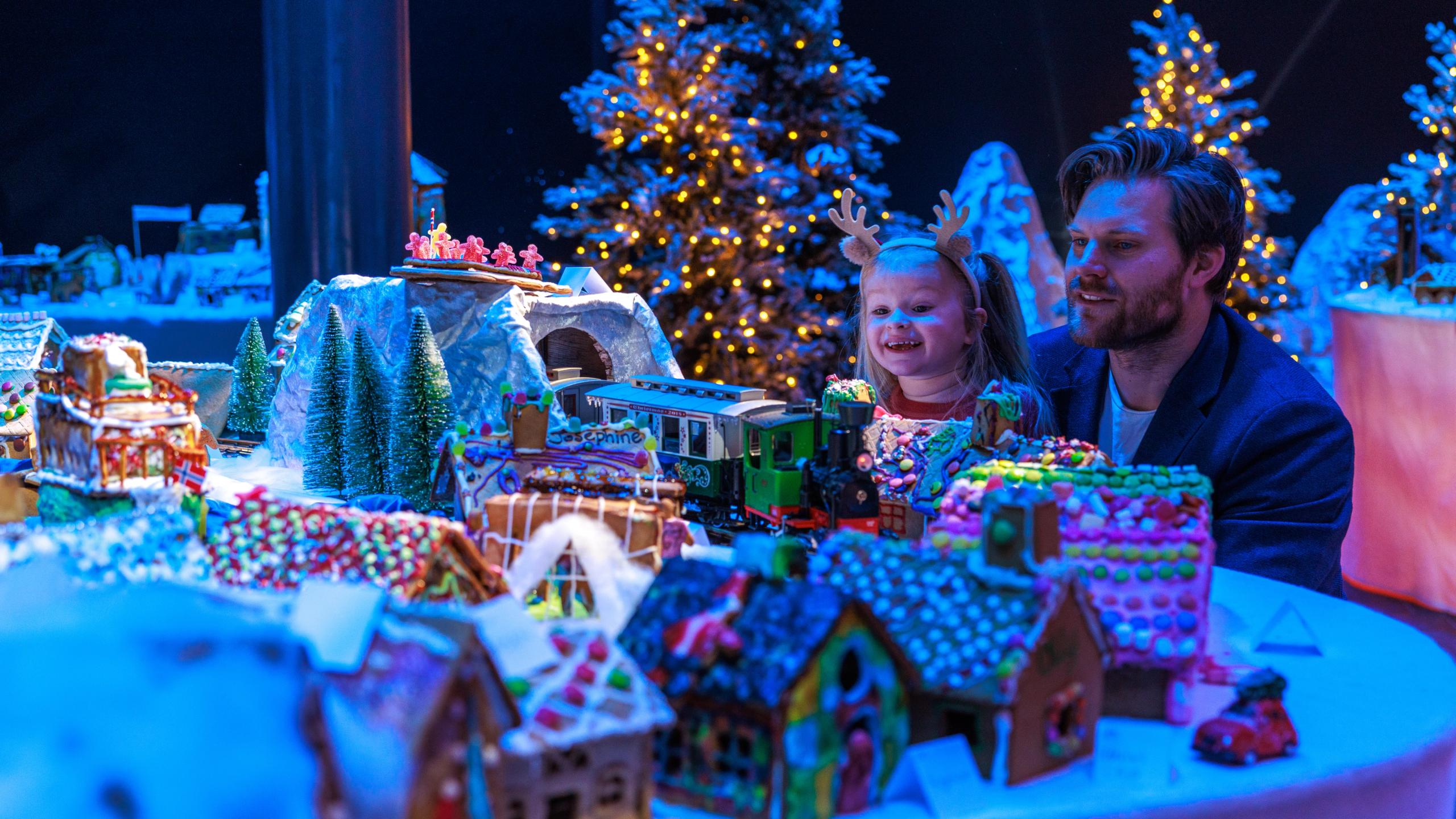 A father and his young daughter looking at the Gingerbread town at the Norwegian Petroleum Museum (Norsk Oljemuseum) in Stavanger
