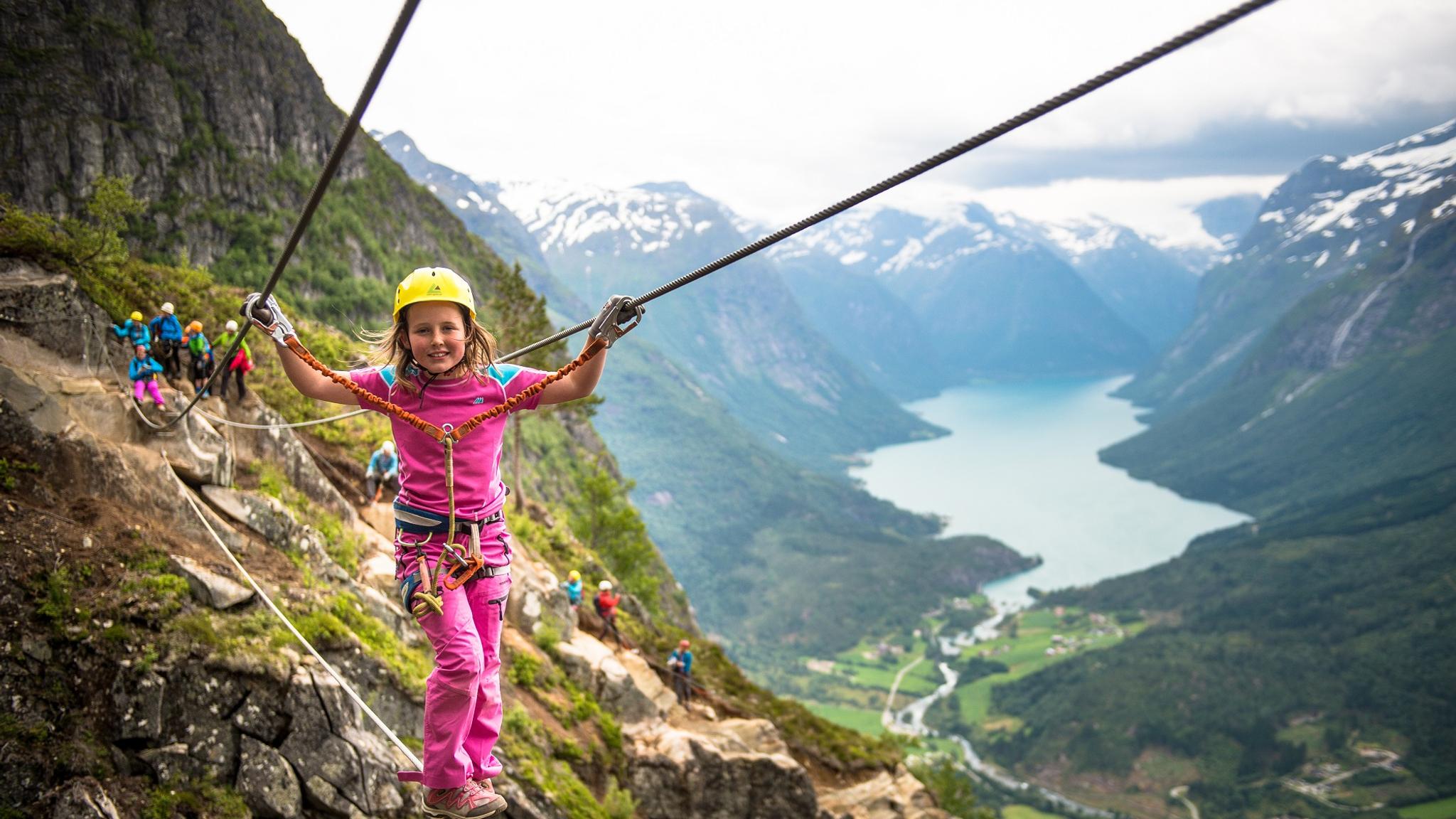 Girl climbing Loen Via Ferrata in Fjord Norway