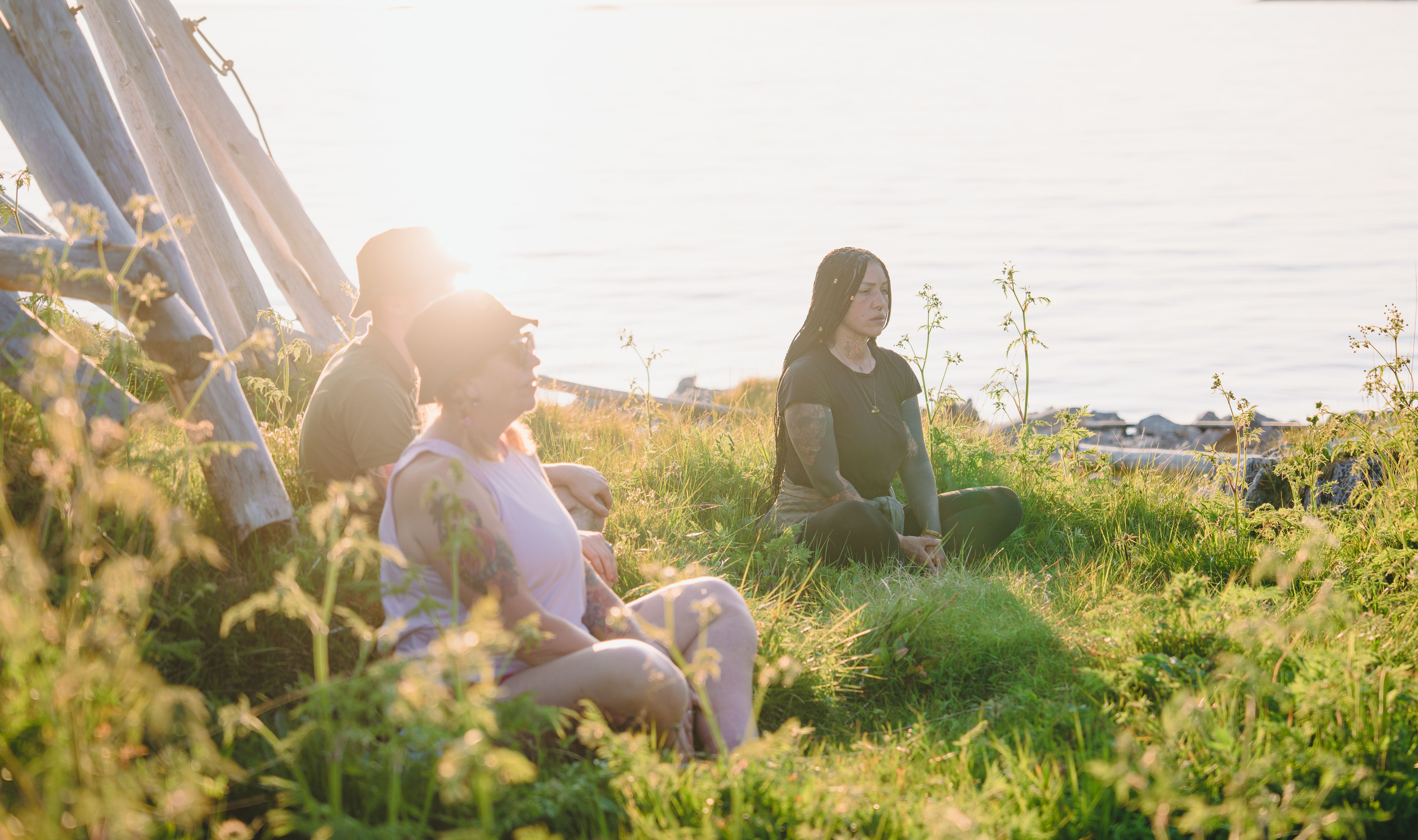 People meditation in the midnight sun in Senja, Troms, Northern Norway.