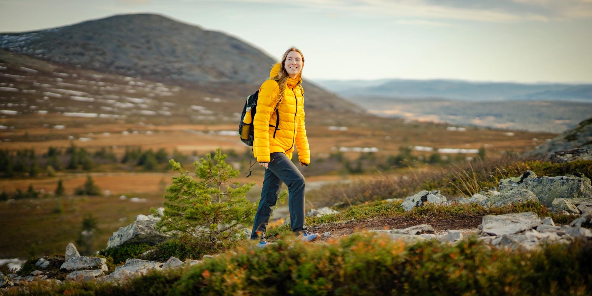 A woman hiking up a mountain in Trysil