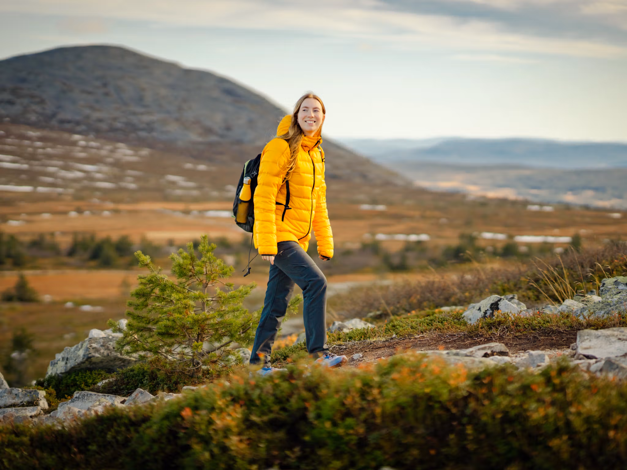 A woman hiking up a mountain in Trysil