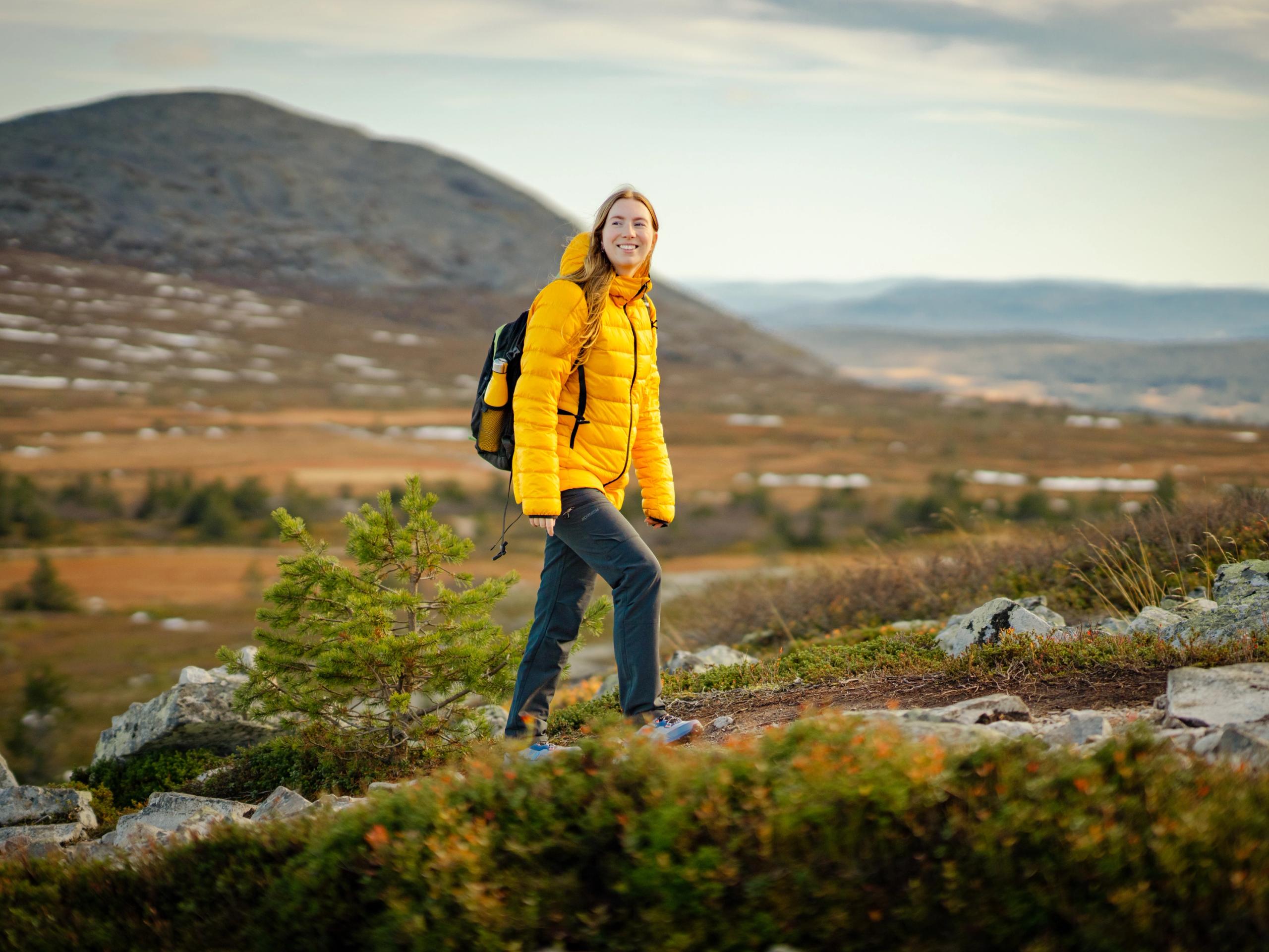 A woman hiking up a mountain in Trysil