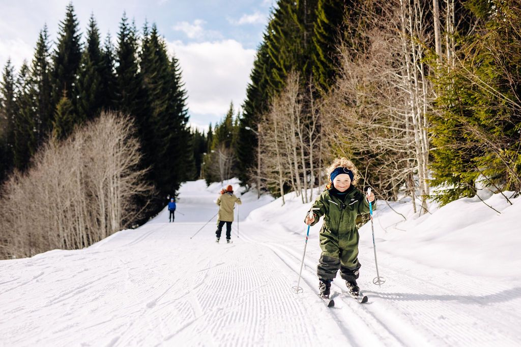 A little boy skiing on cross-country trails.
