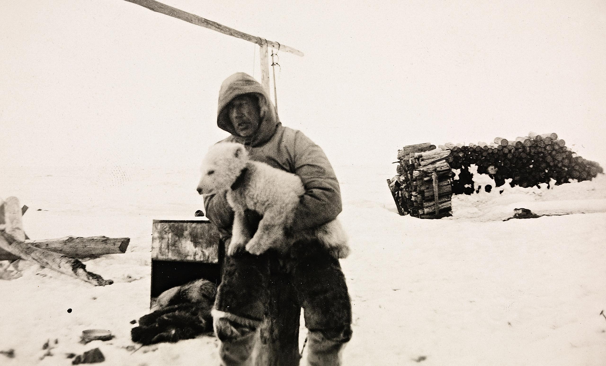 Roald Amundsen in a snowy landscape with his dog in Ajon, Russia