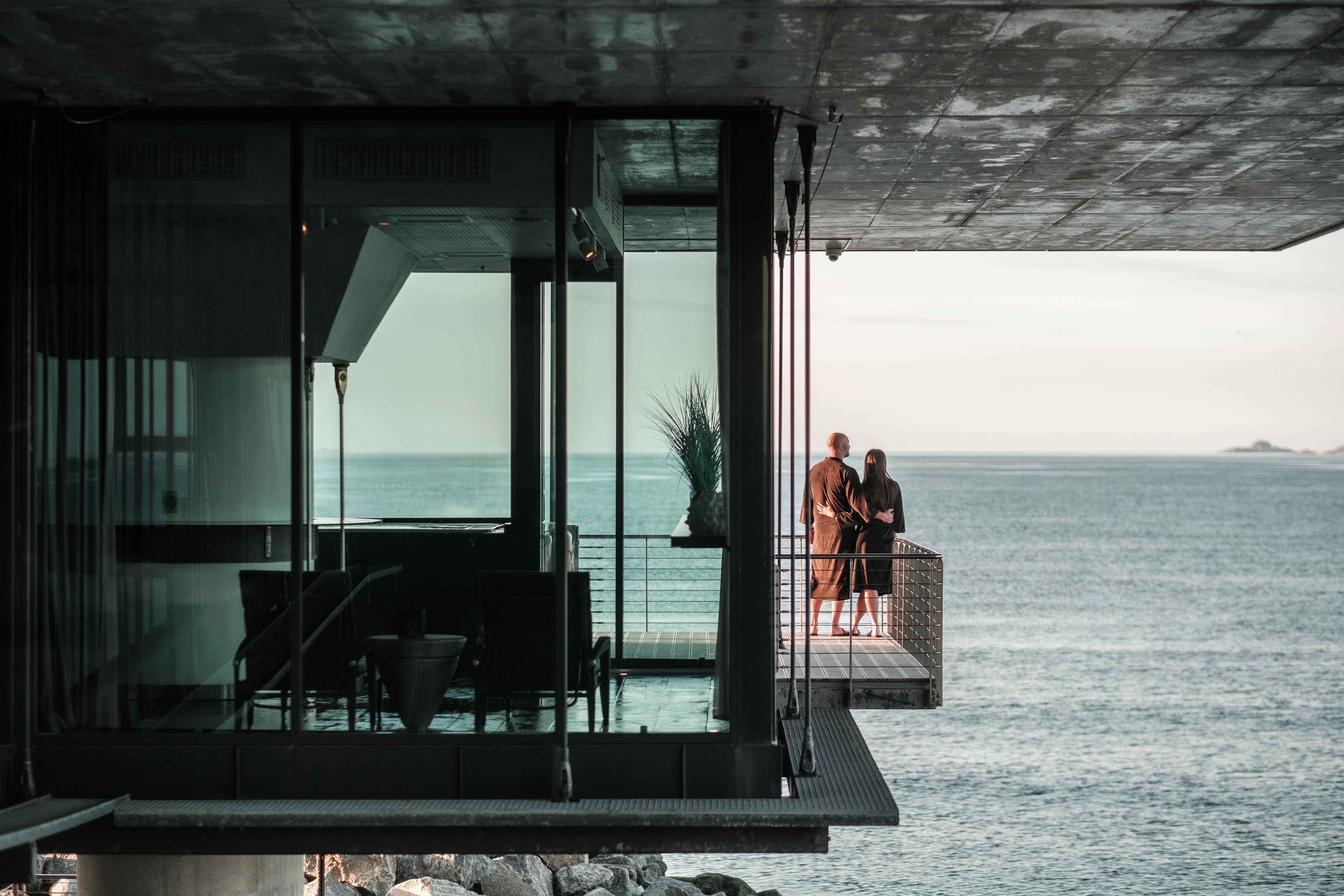 A couple at a spa with a sea view.
