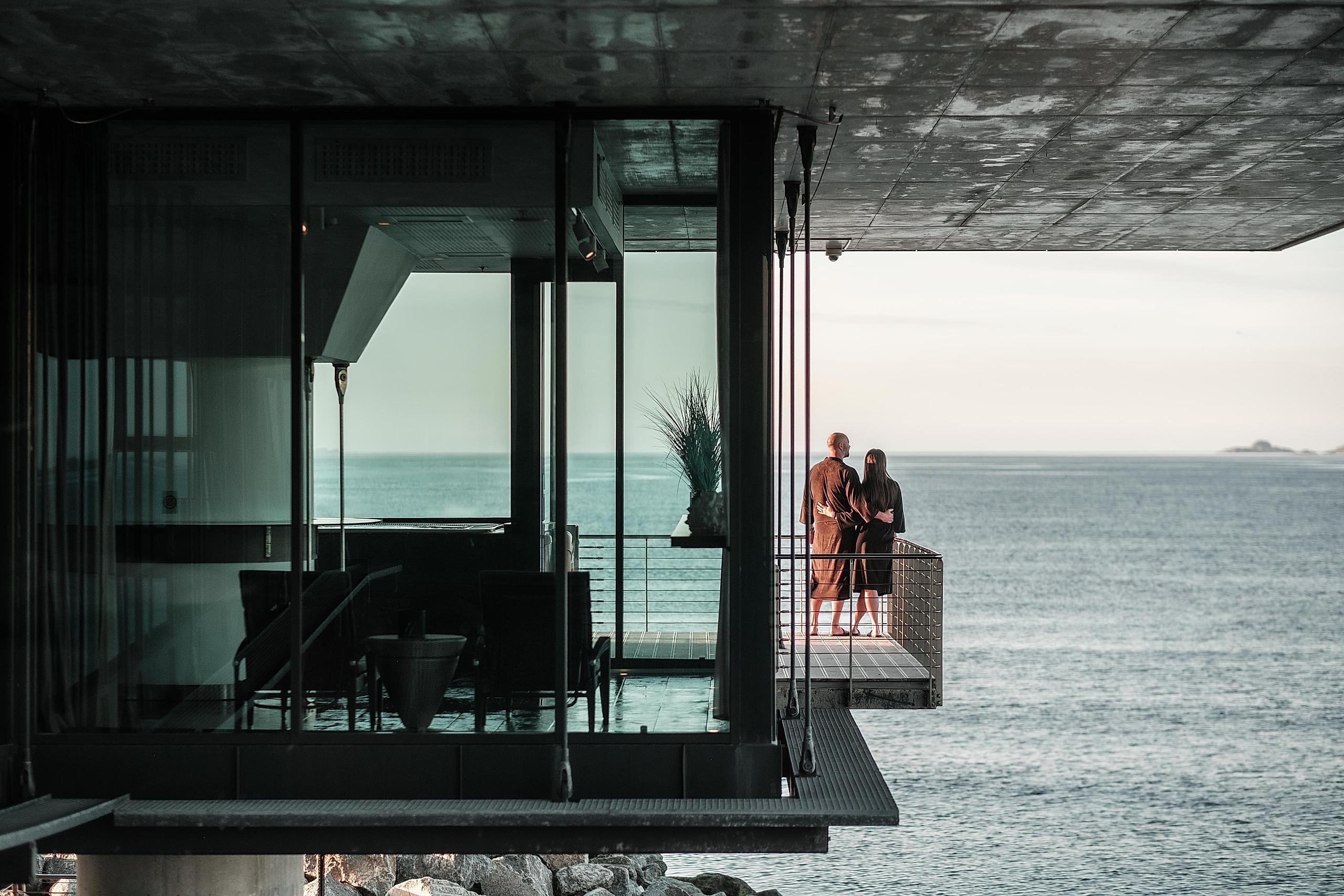 A couple at a spa with a sea view.
