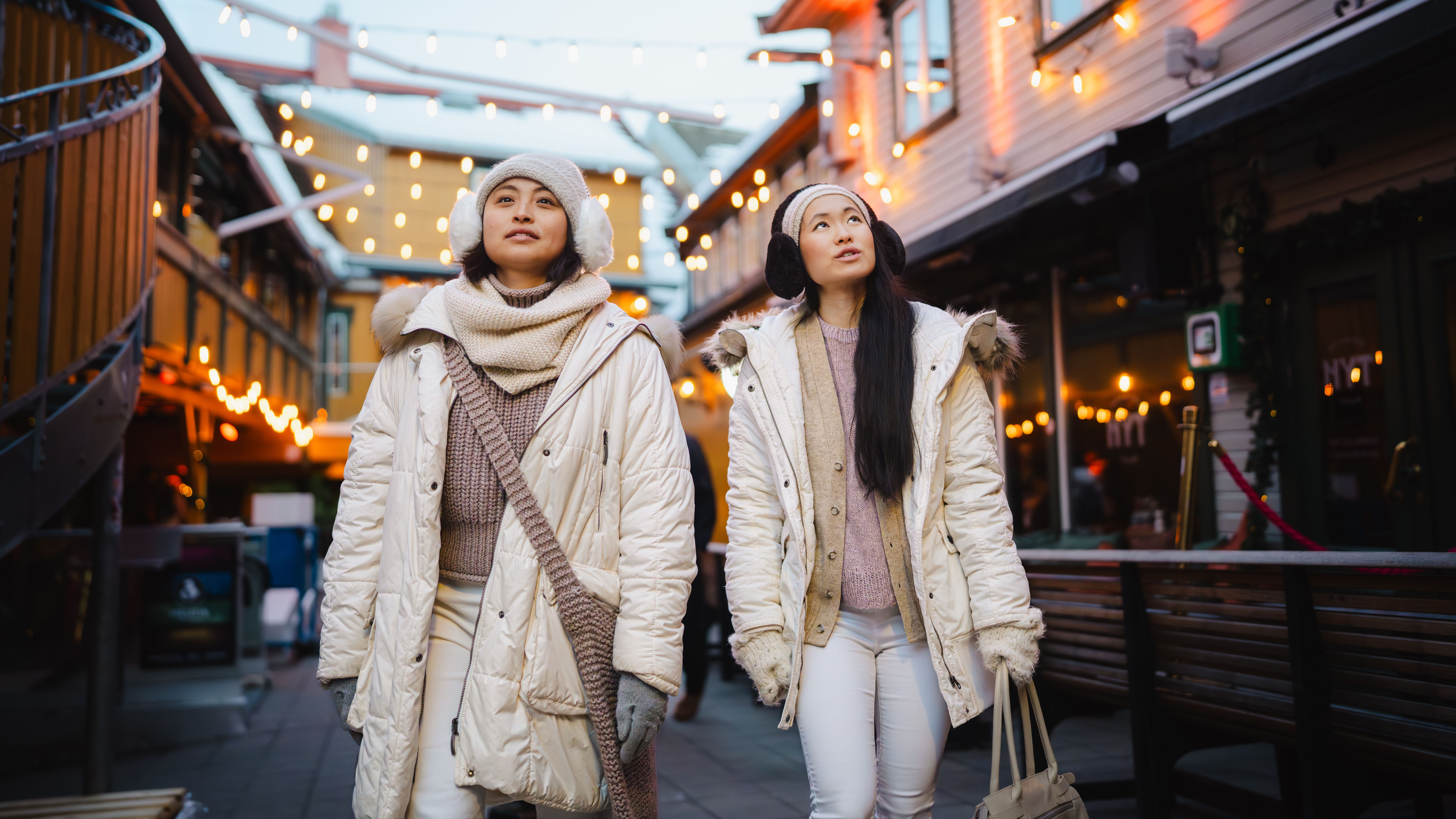 Two girls walking in the city centre of Tromsø.