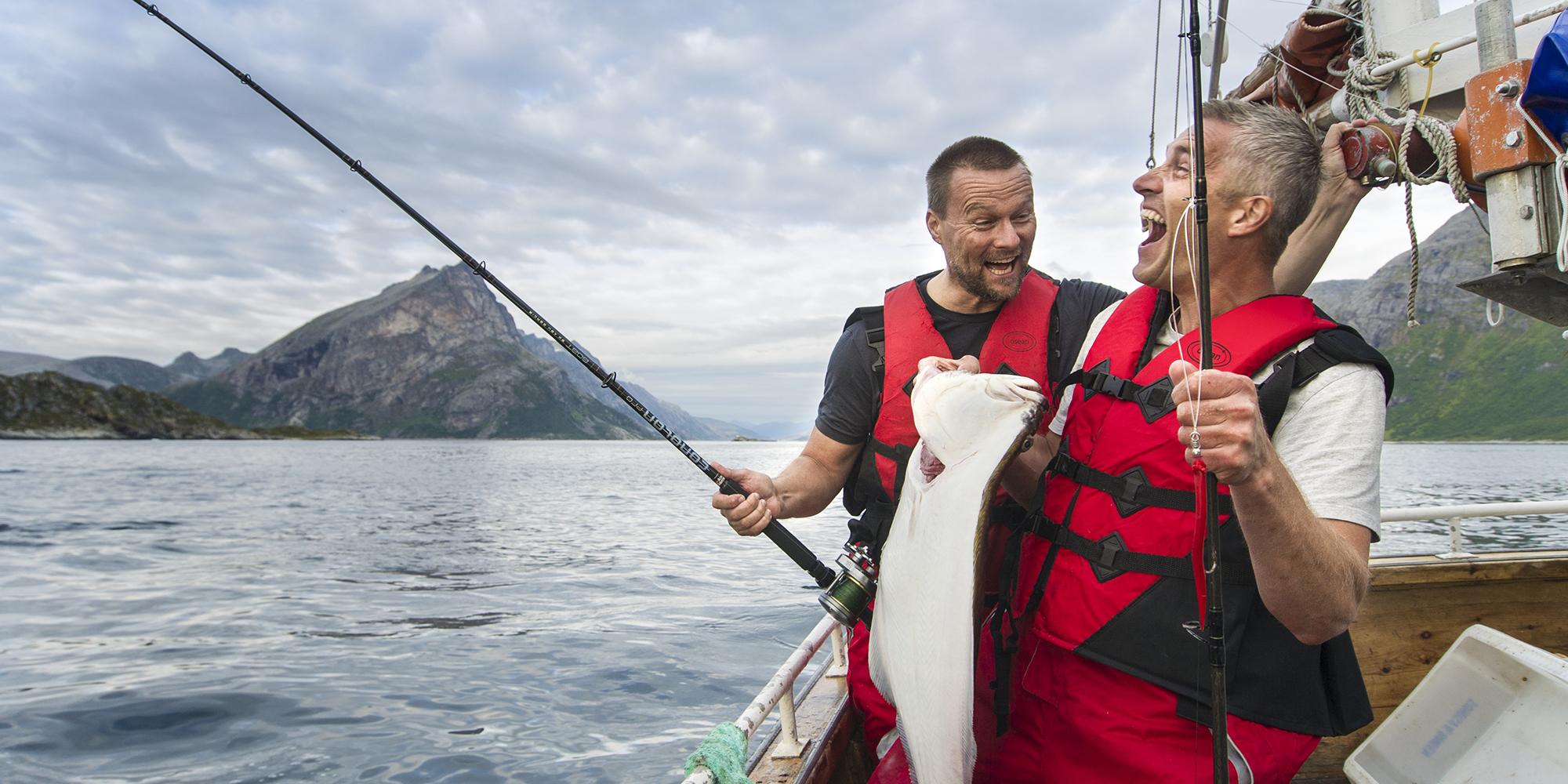 Two men fishing in boat in Tromsø