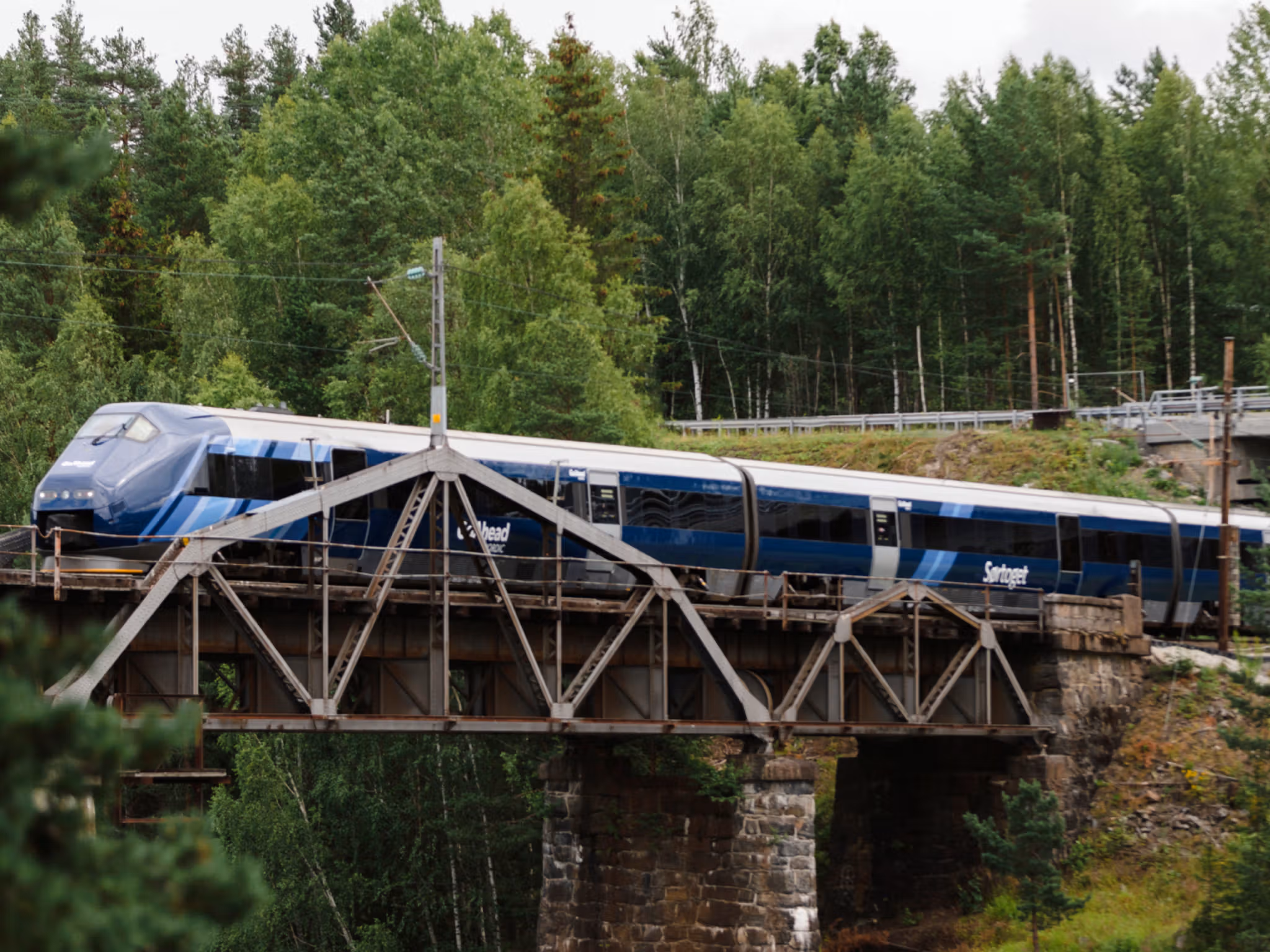 The Sørland Line driver over a bridge in the forest, Norway