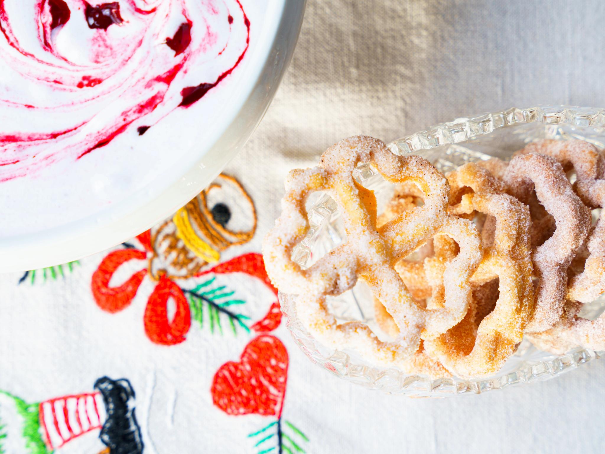 Rosette biscuits on a plate with trollkrem on the side