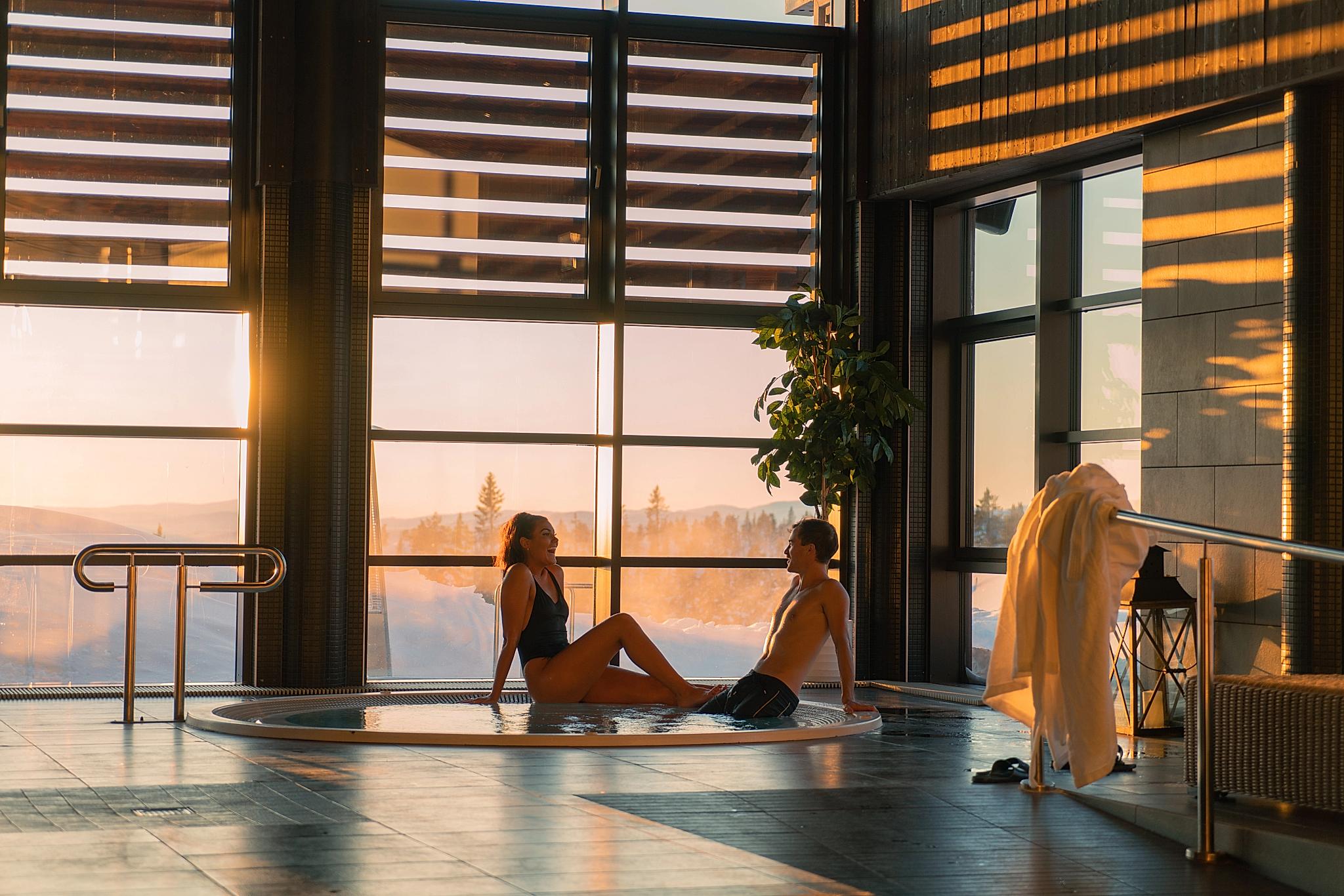 Two people sitting by a pool at Norefjell Ski and Spa