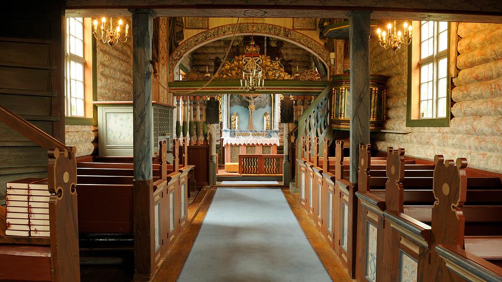 The inside of an old wooden church.