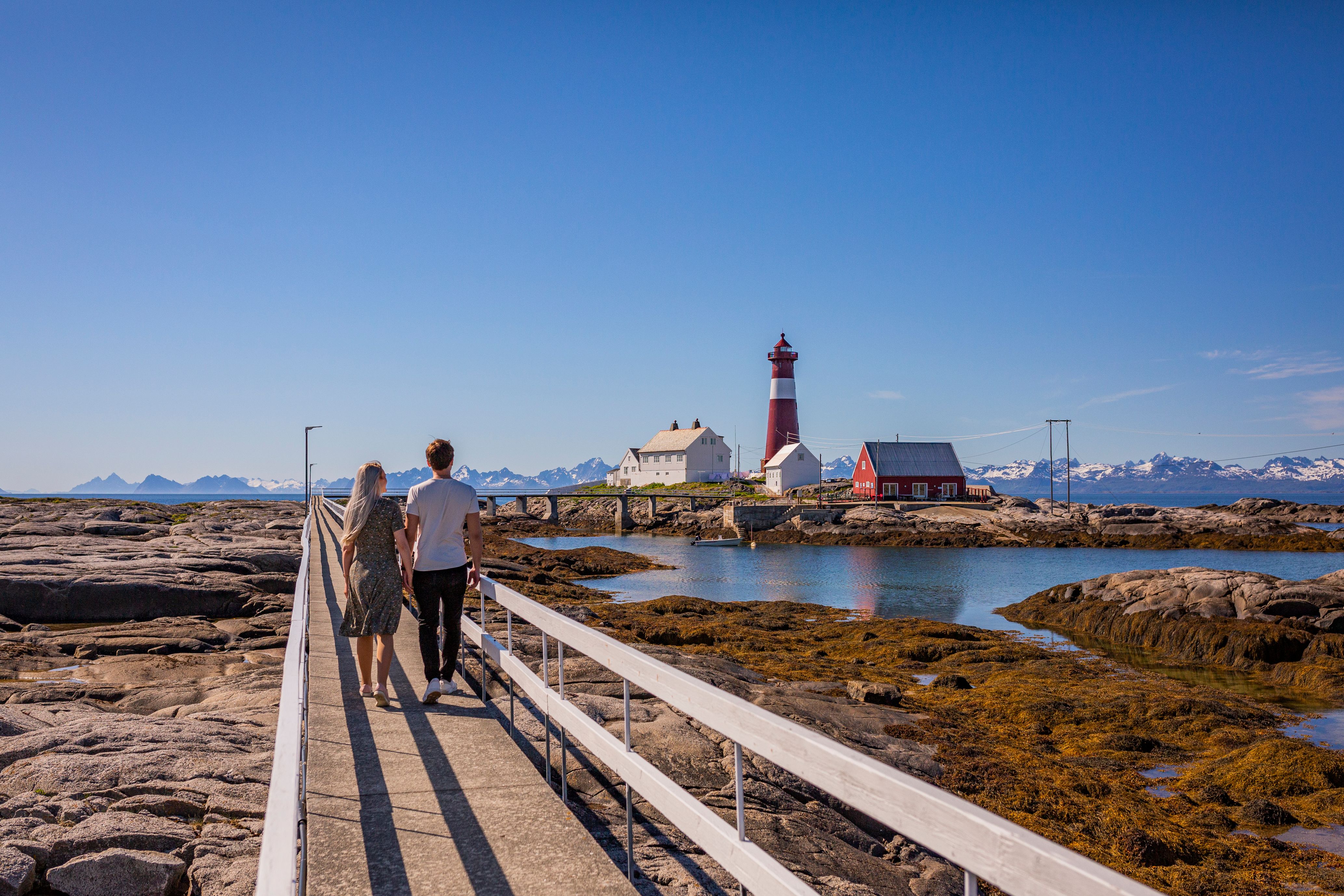 A couple walking towards Tranøy Fyr in Salten, Northern Norway