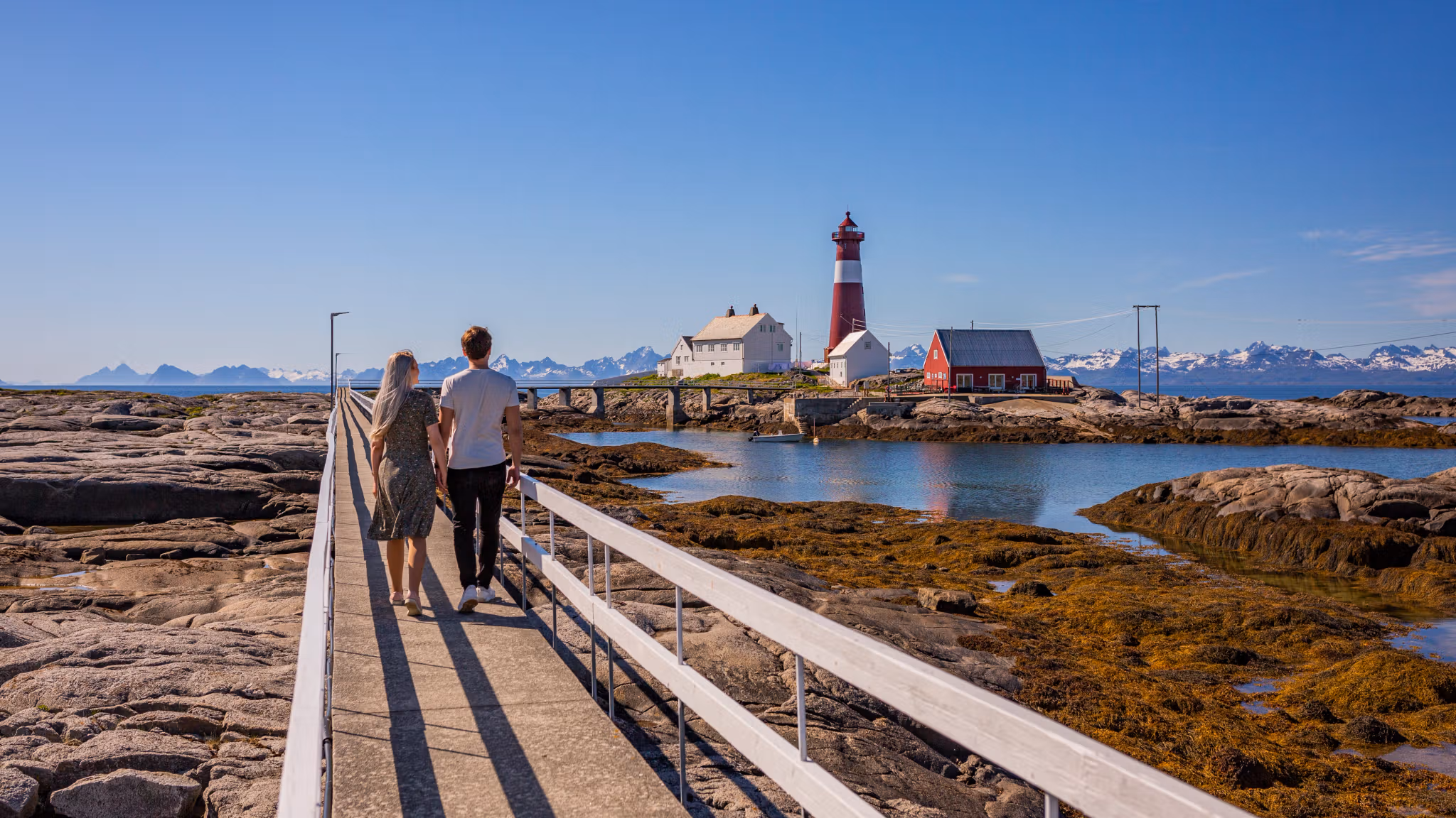 A couple walking towards Tranøy Fyr in Salten, Northern Norway