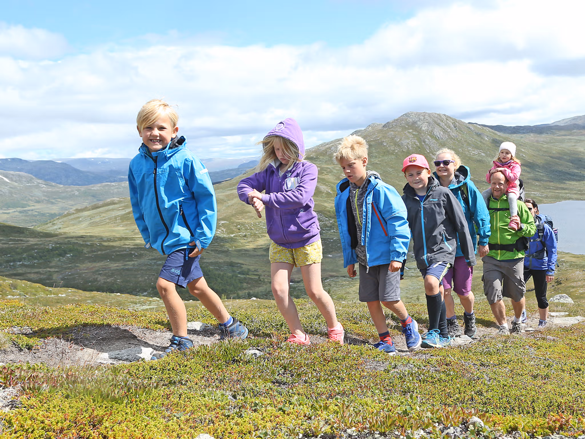 A group of adults and children hiking in the Hemsedal mountains in Eastern Norway