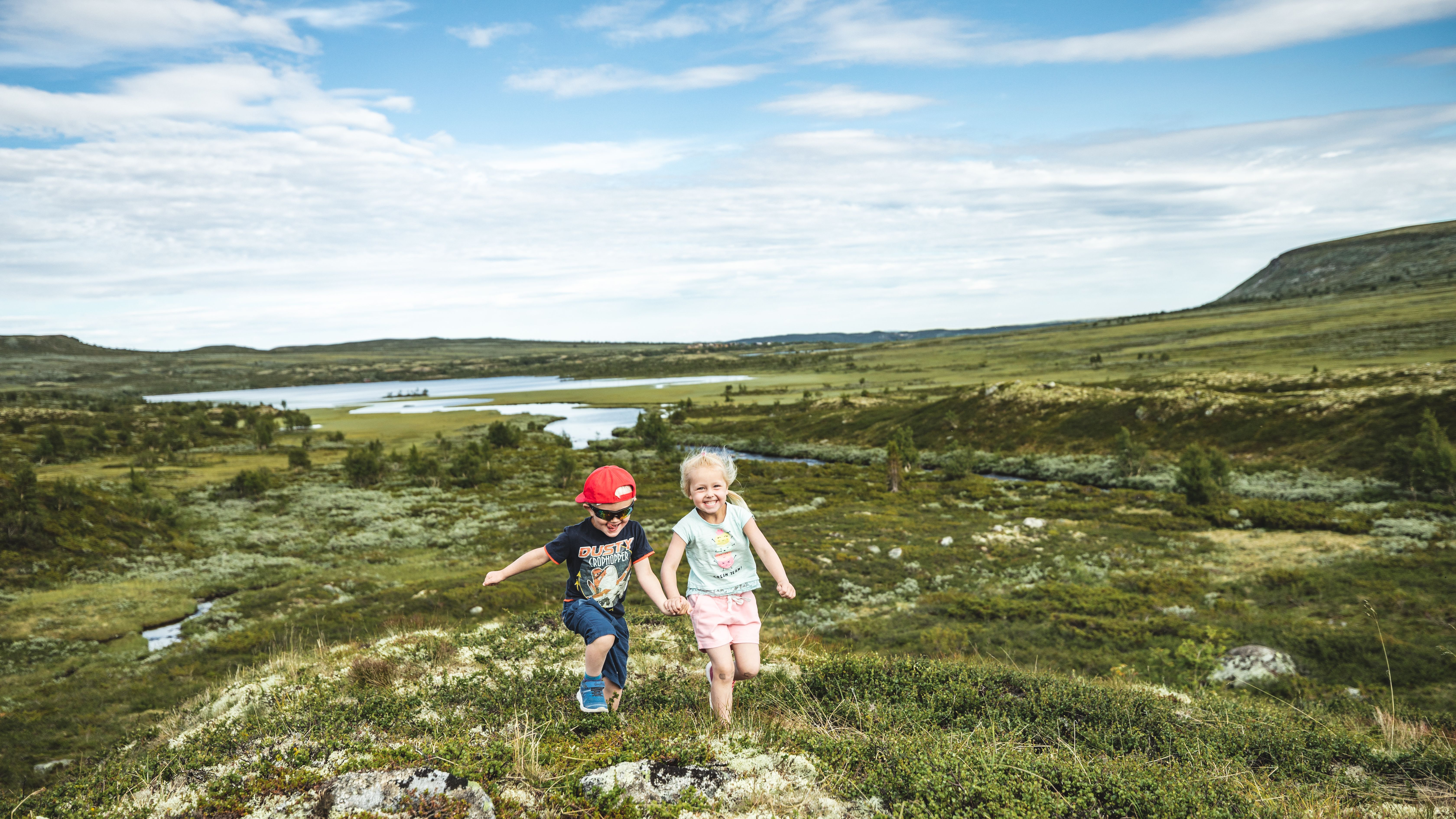 Two children are running in the mountains of Hallingdal, Eastern Norway