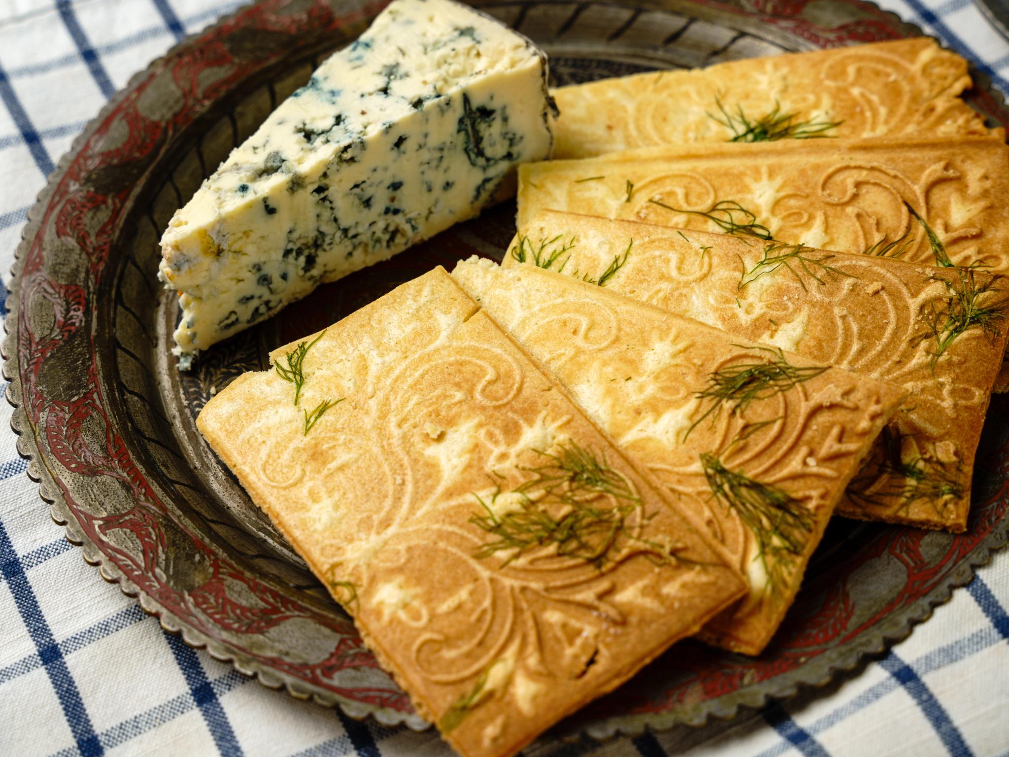 Close-up of goro cookies flavored with dill and blue cheese, showing their traditional patterned shape with a modern savory twist