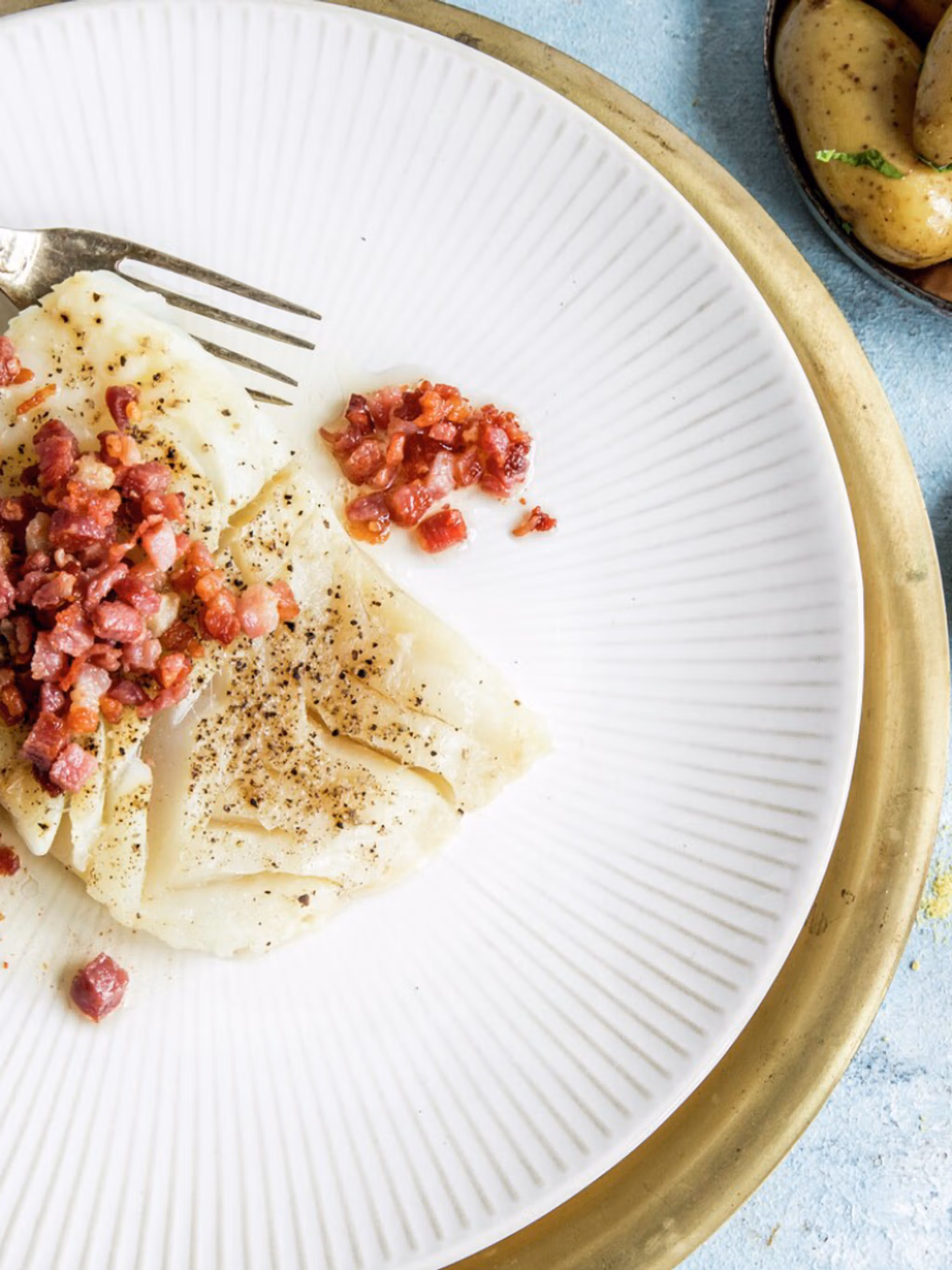 A plate of lutefisk and bacon served with potatoes