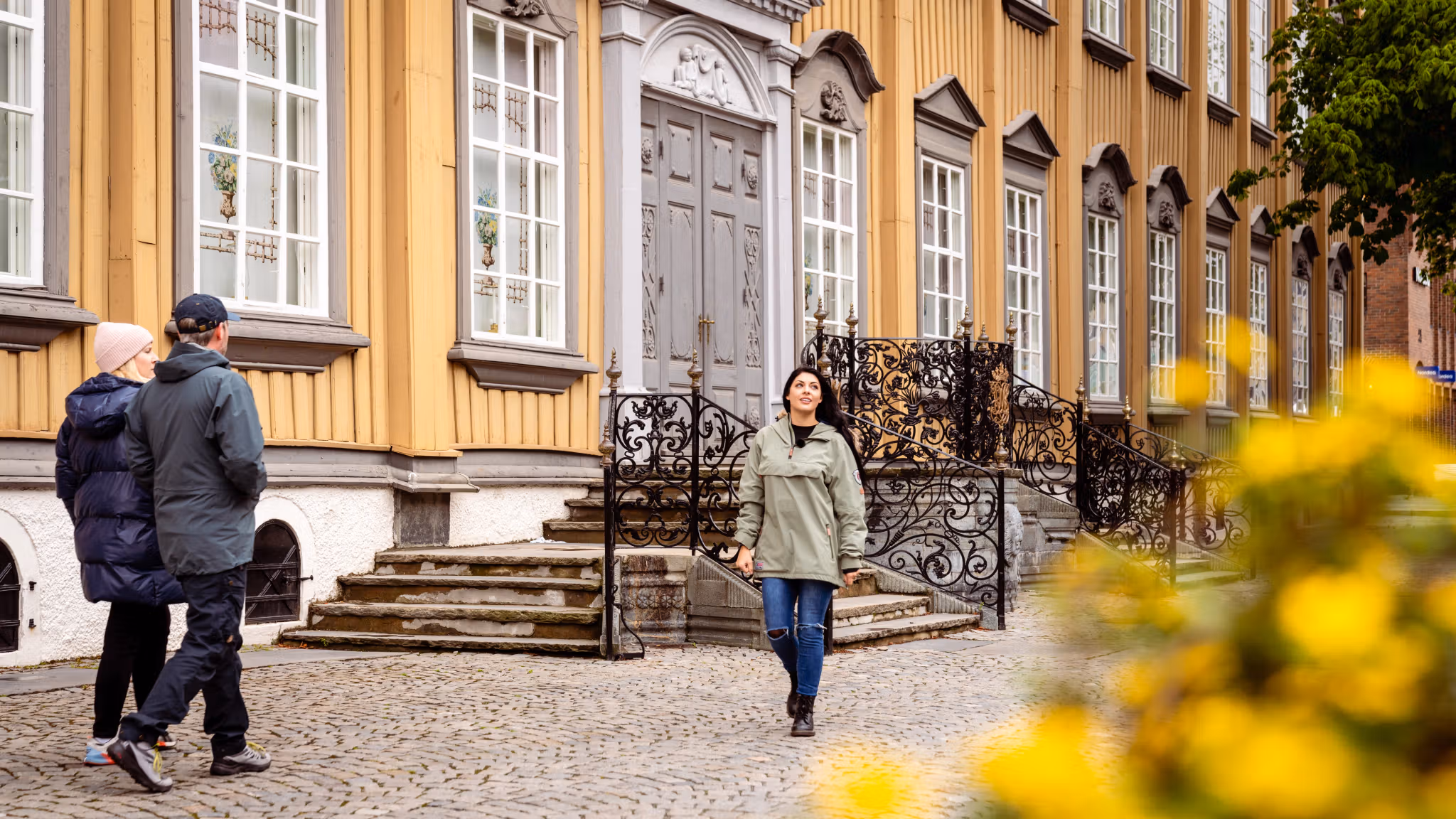 A woman walking past Stiftsgården in Trondheim