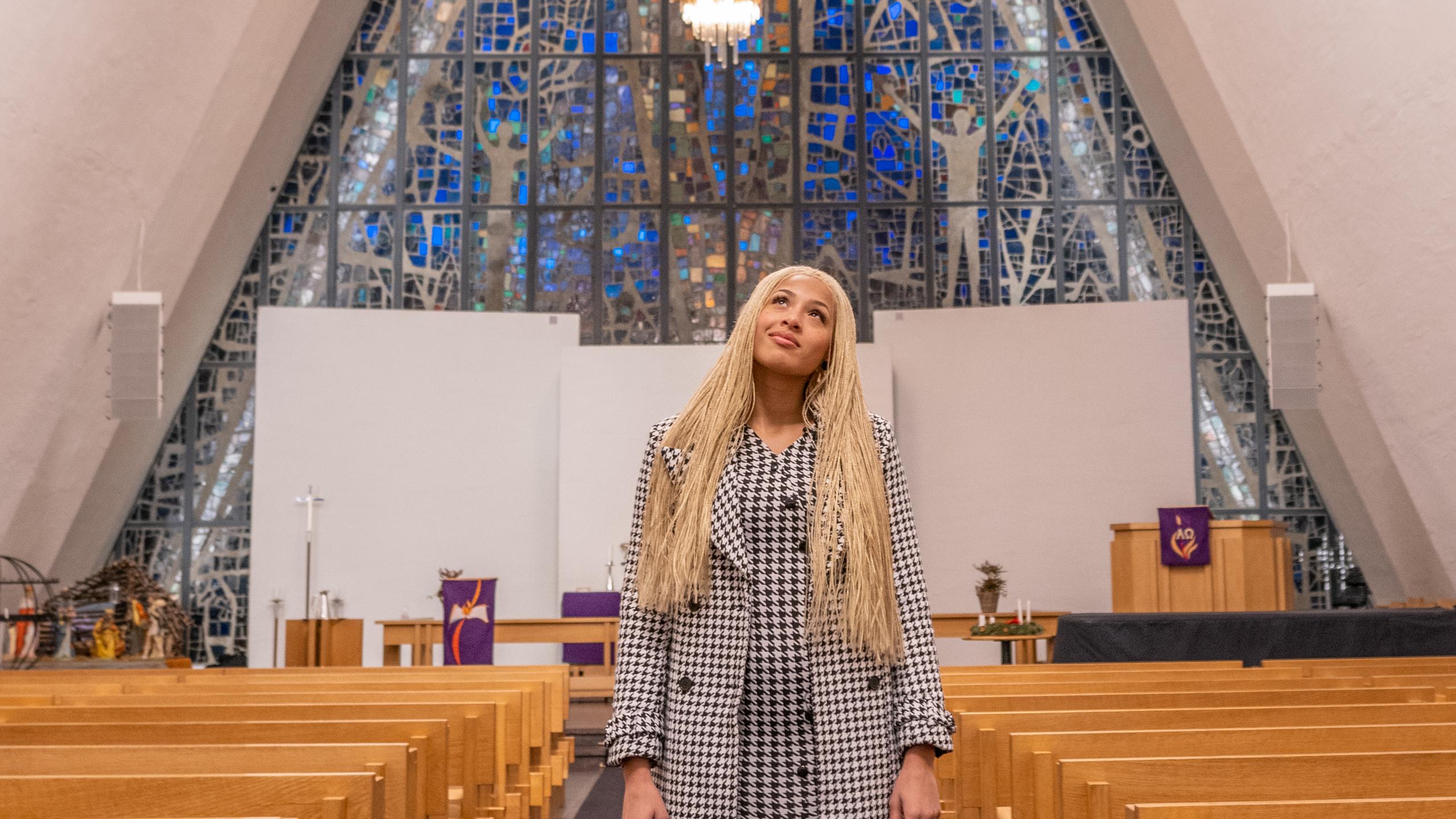 Artist Ida Tolou standing in the beautiful Arctic Cathedral in Tromsø