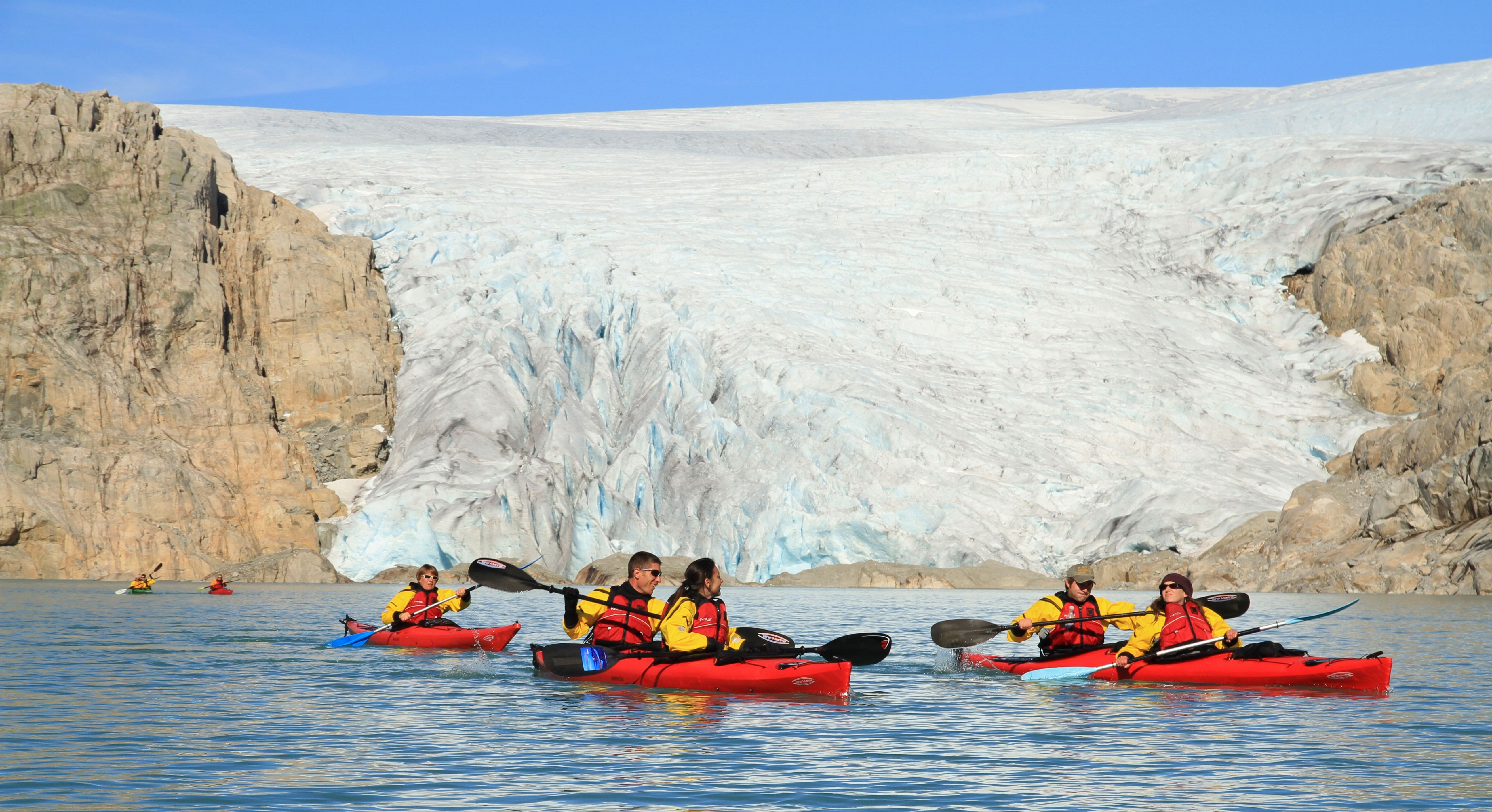 Five people kayaking close to the Folgefonna glacier in Kvinnherad
