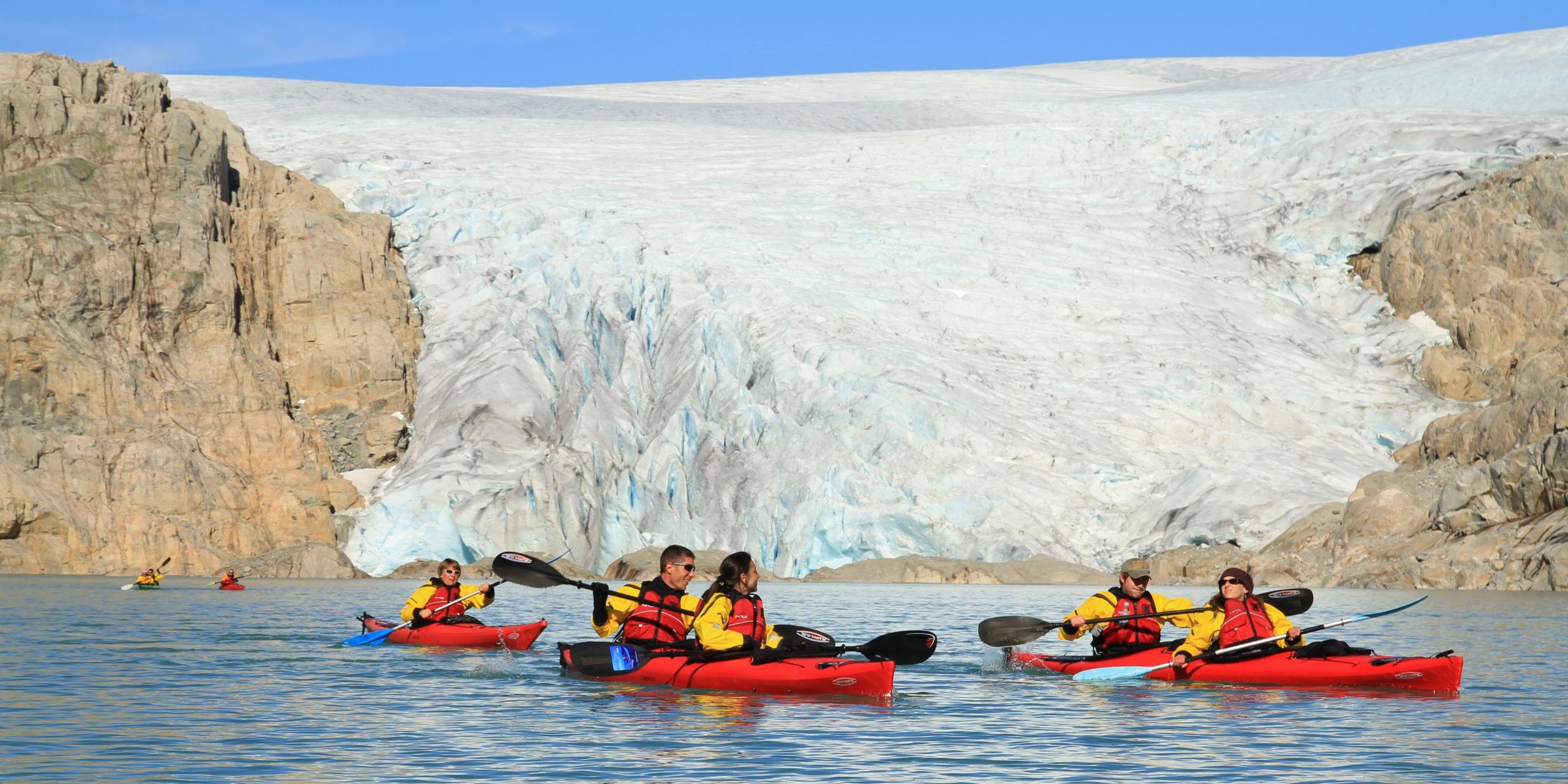 Five people kayaking close to the Folgefonna glacier in Kvinnherad