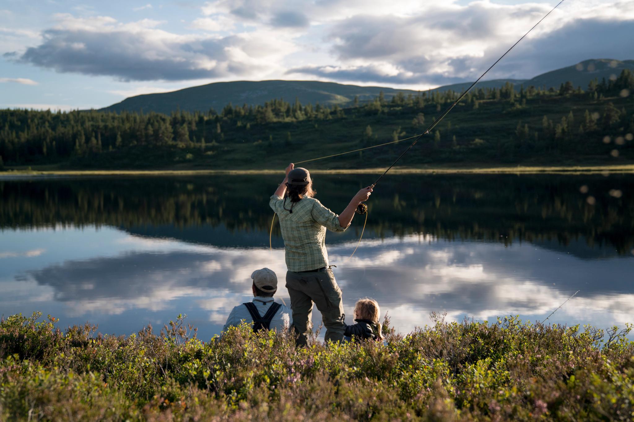 A woman and her family is fly fishing in a lake in Blefjell, Eastern Norway