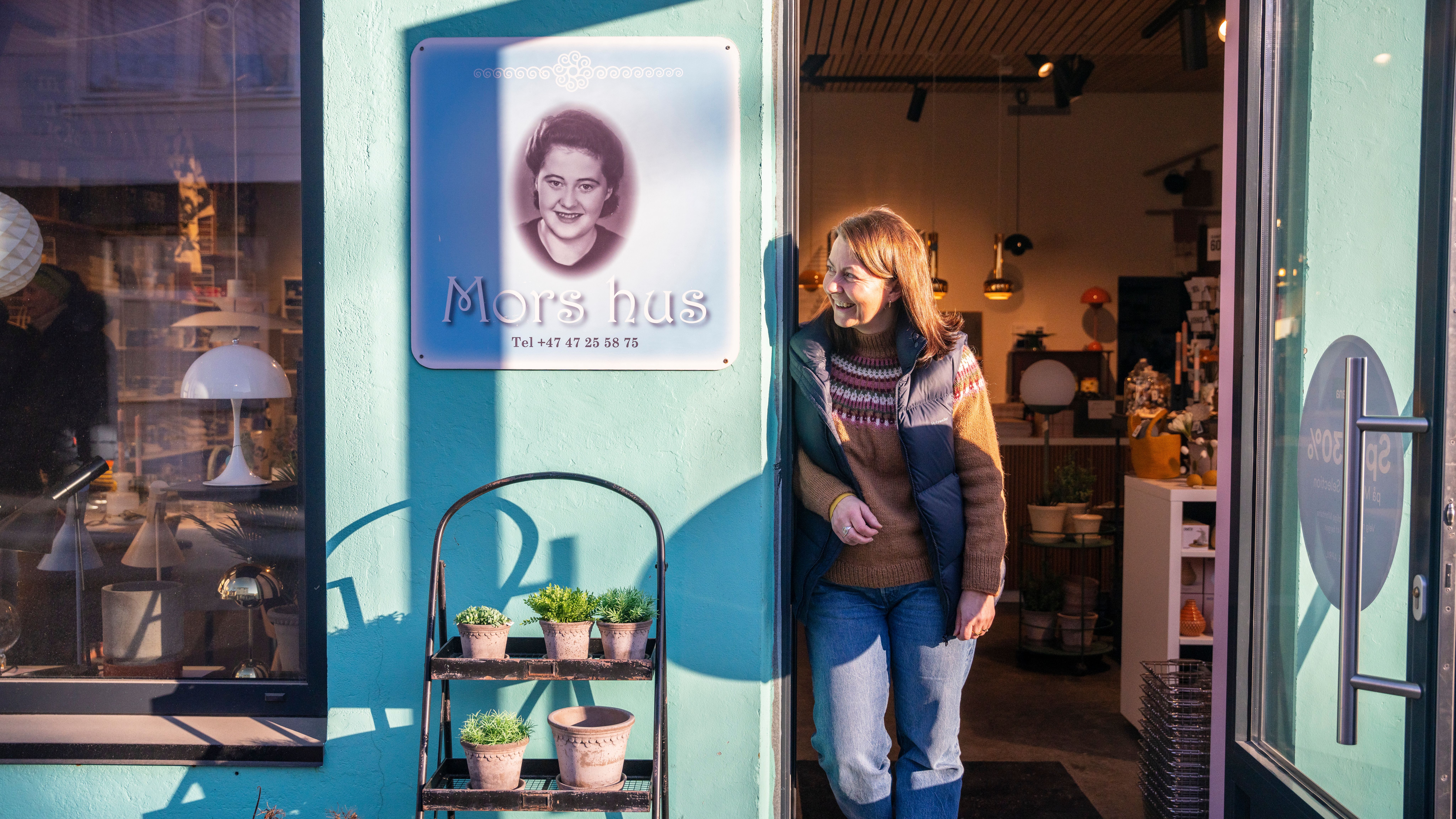A woman looking out of a door.