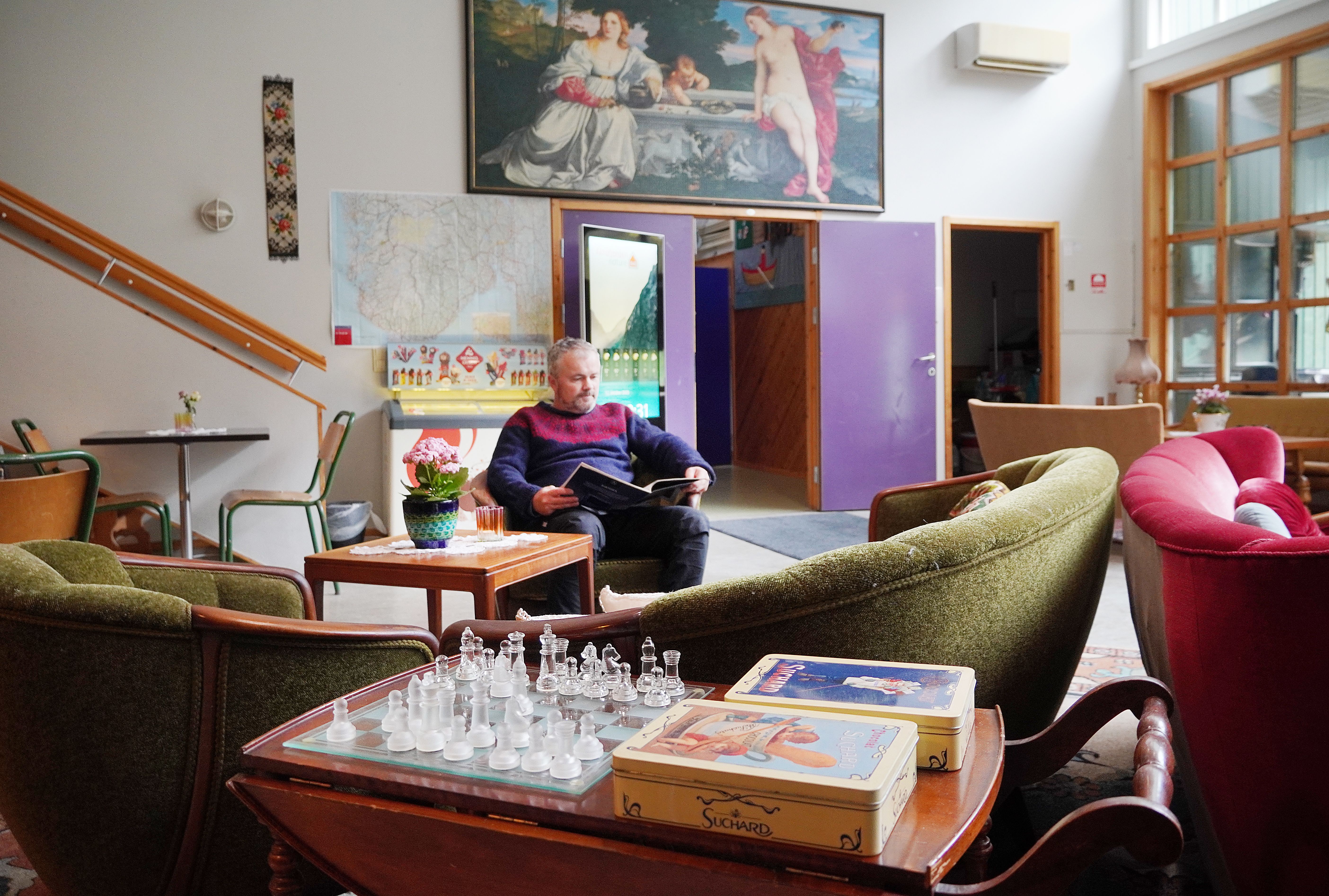 A man reading a book at Åkrafjorden Nature B&B 