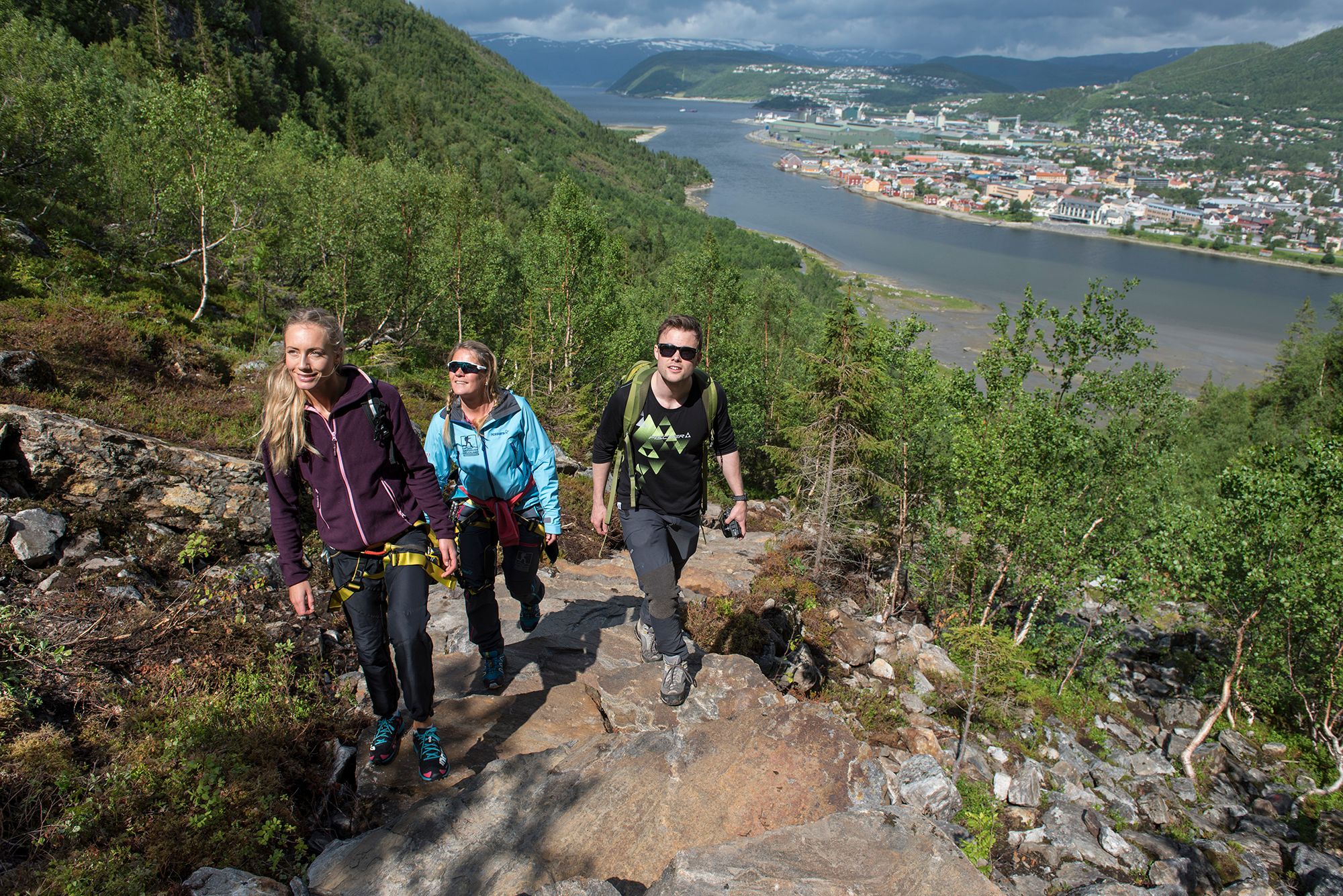 Three people hiking the Helgelandstrappa sherpa stairs in Mosjøen, Helgeland, Northern Norway