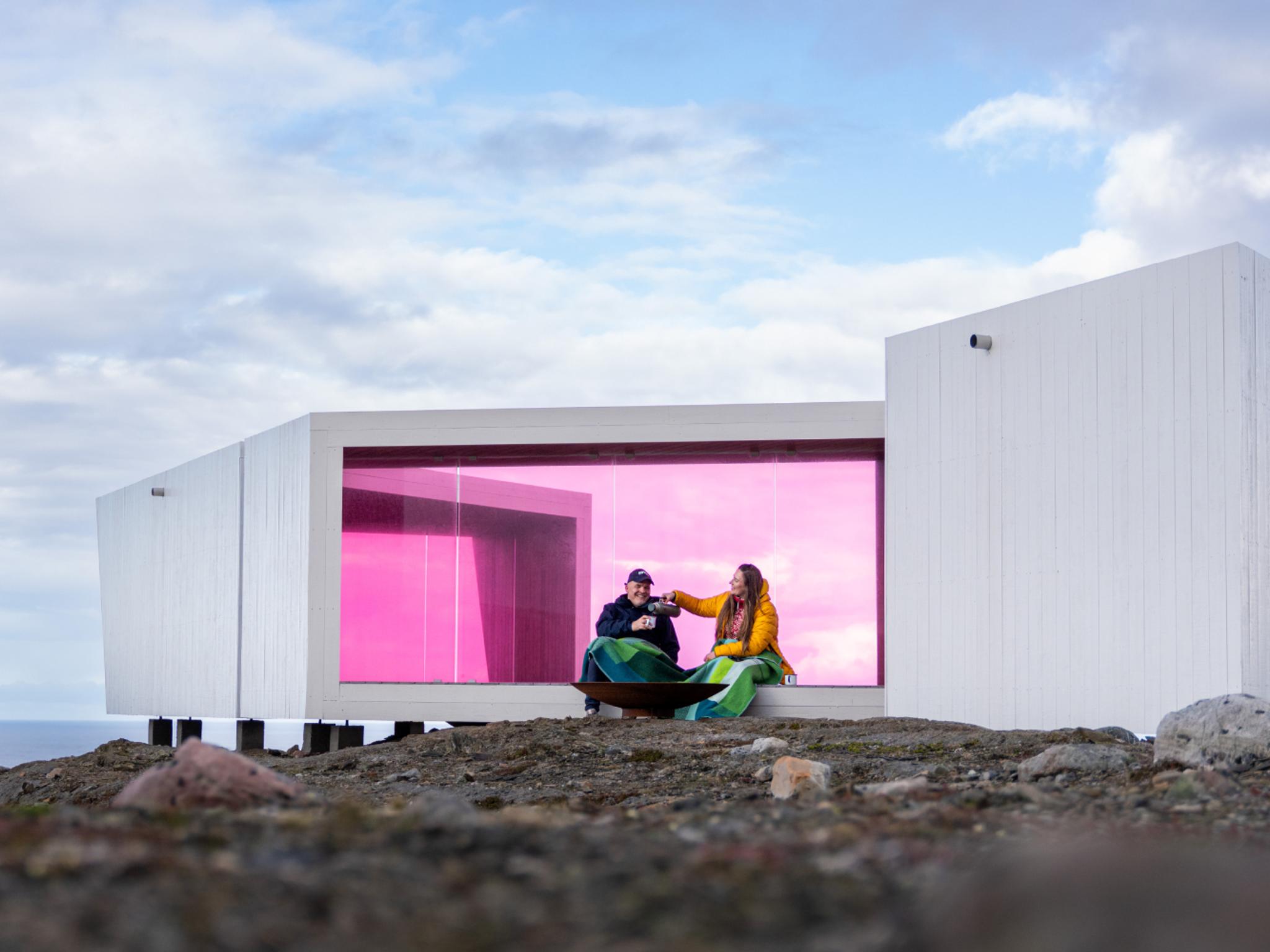 Two poeple sitting in Domen viewpoint by Biptope in Varanger, Northern Norway