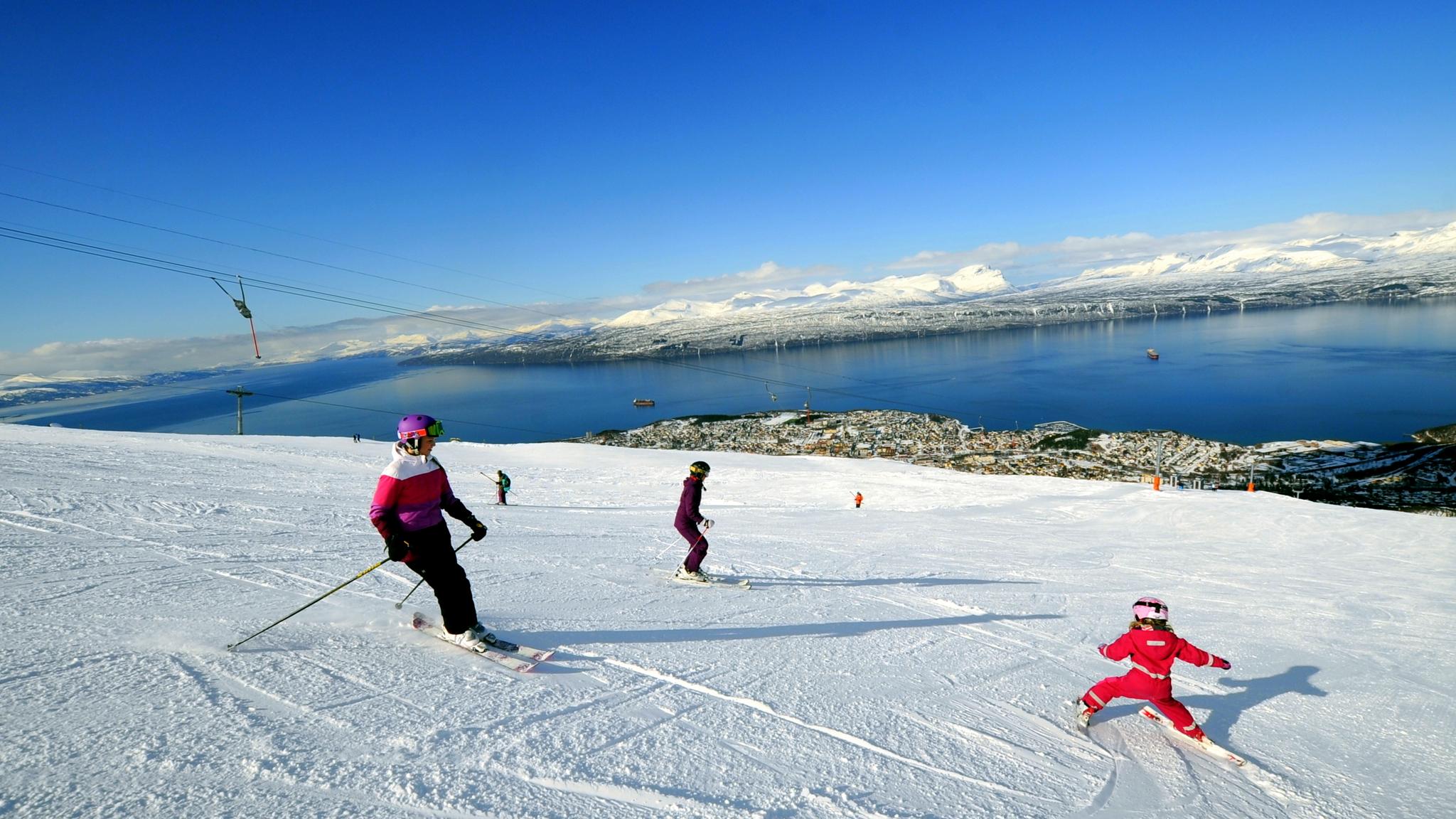 People are skiing at Narvikfjellet ski resort in Narvik, Northern Norway