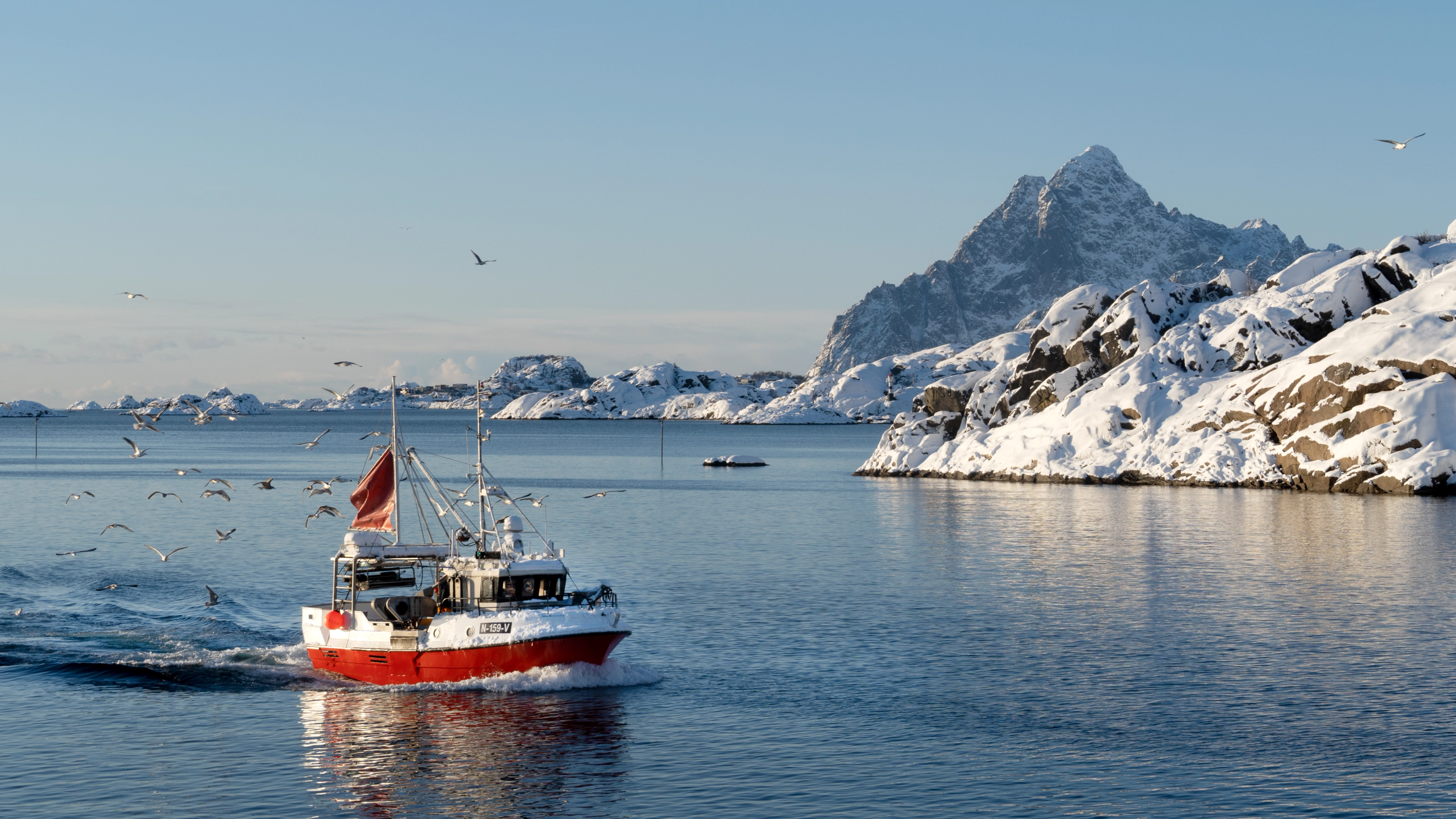 Skreifiskebåt foran Vågakallen i Lofoten